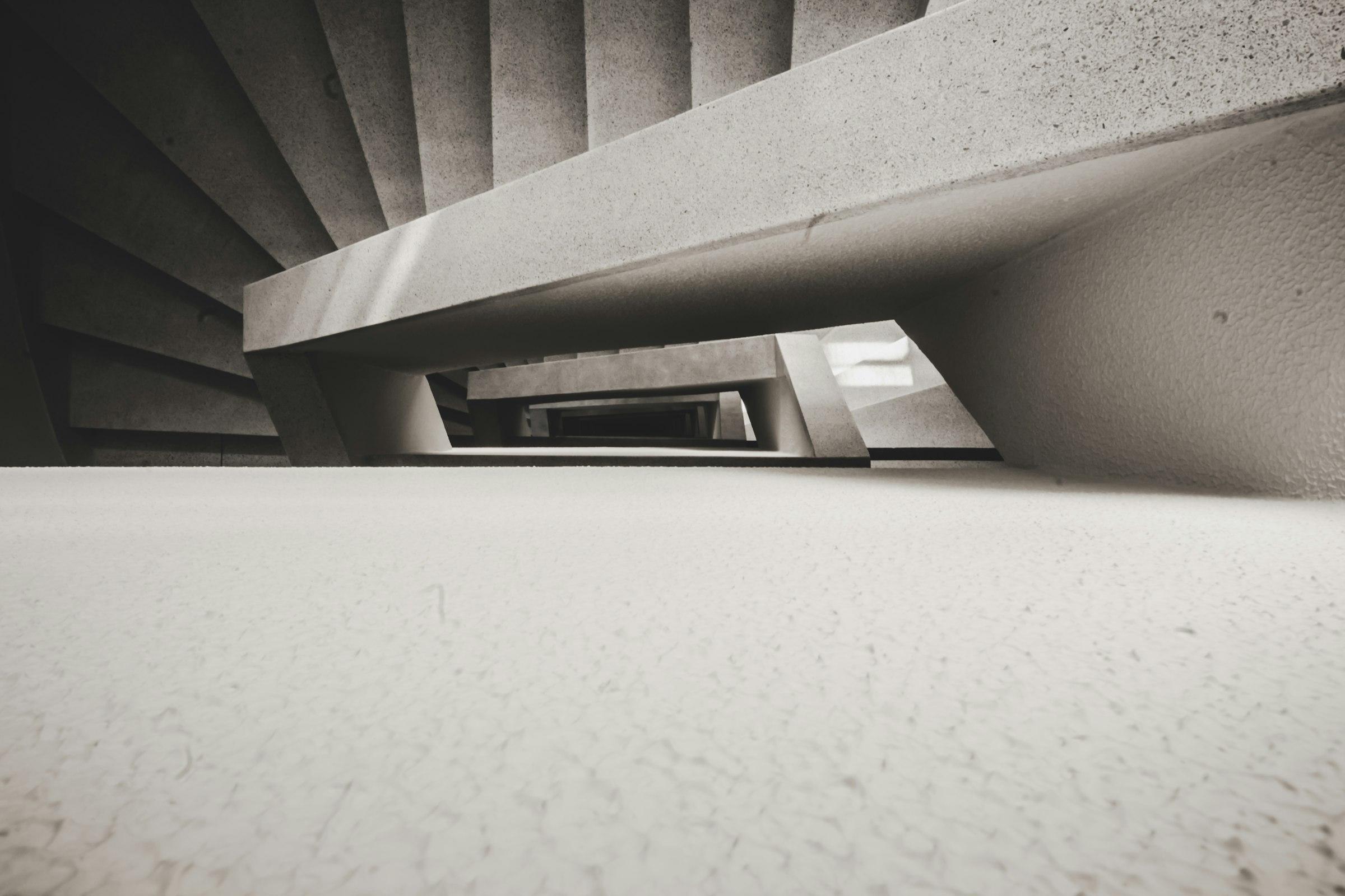 A white concrete spiral staircase seen from above