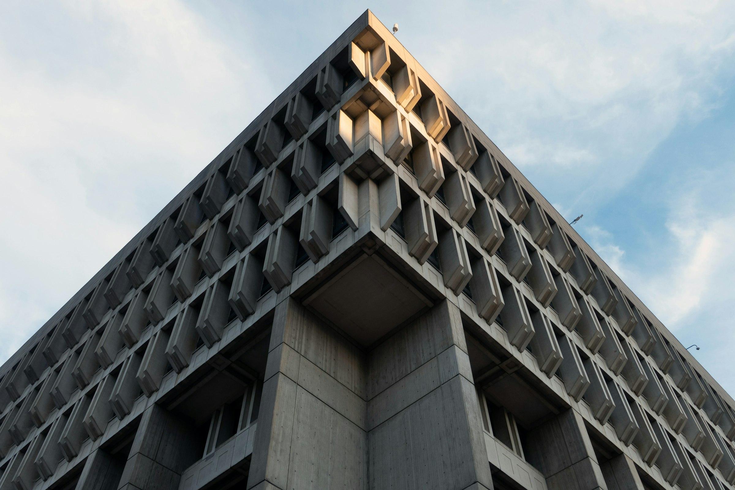 Gray concrete building under a blue sky during daytime