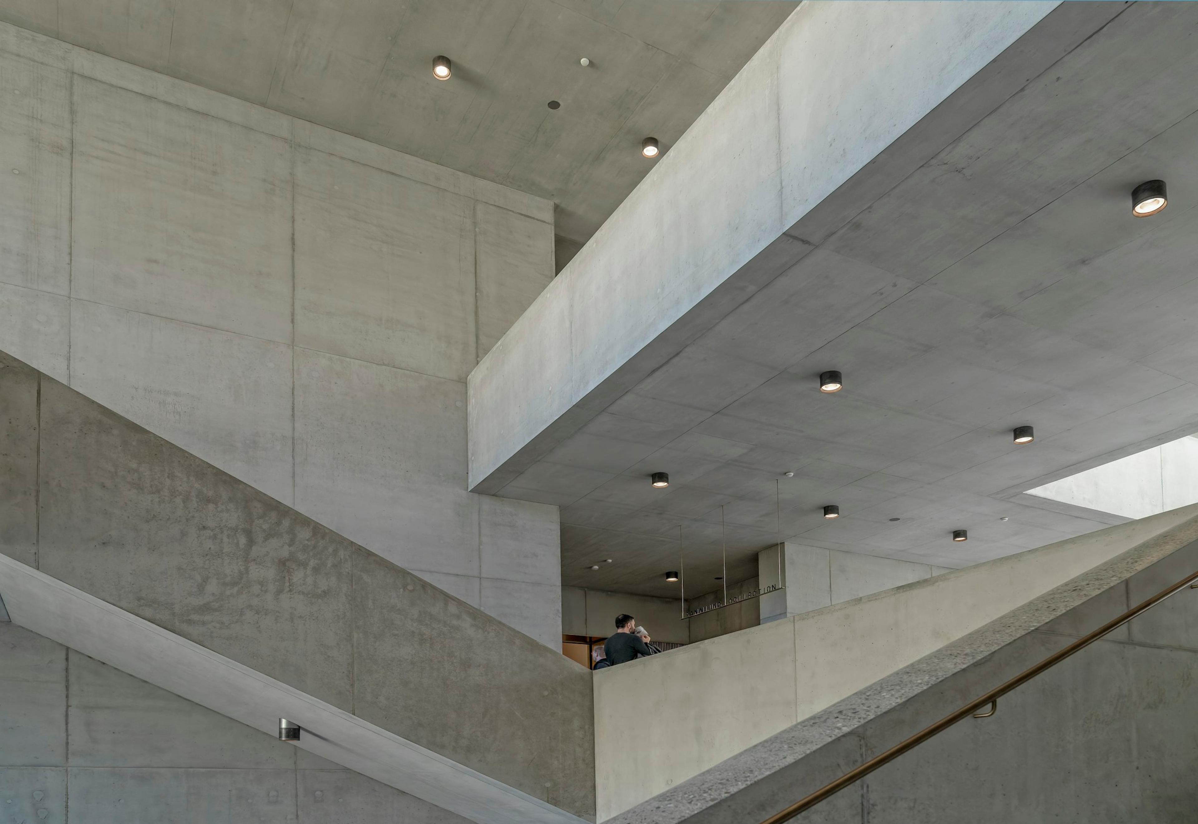 A person sitting on a broad concrete staircase