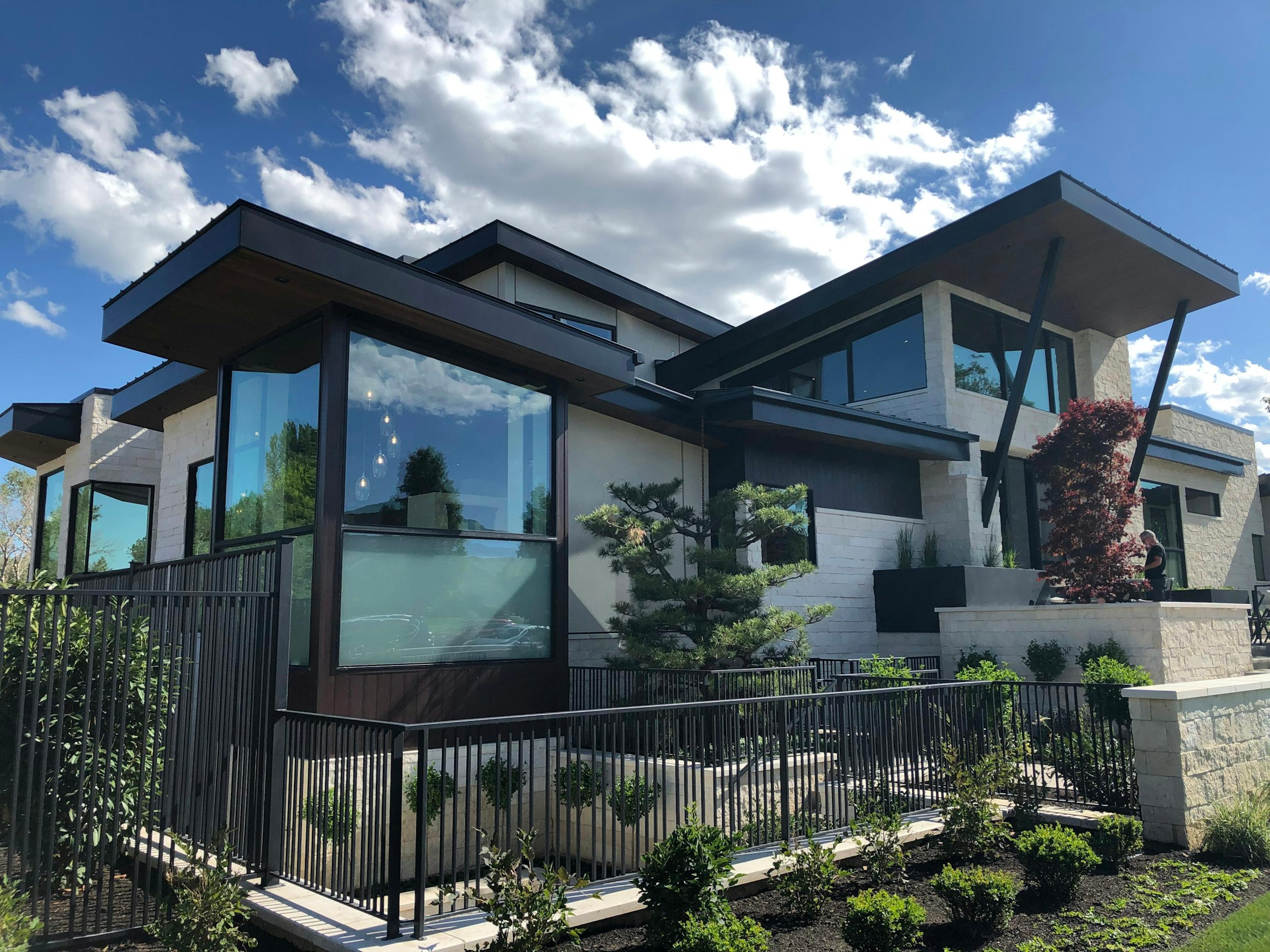A white and timber house under a blue sky