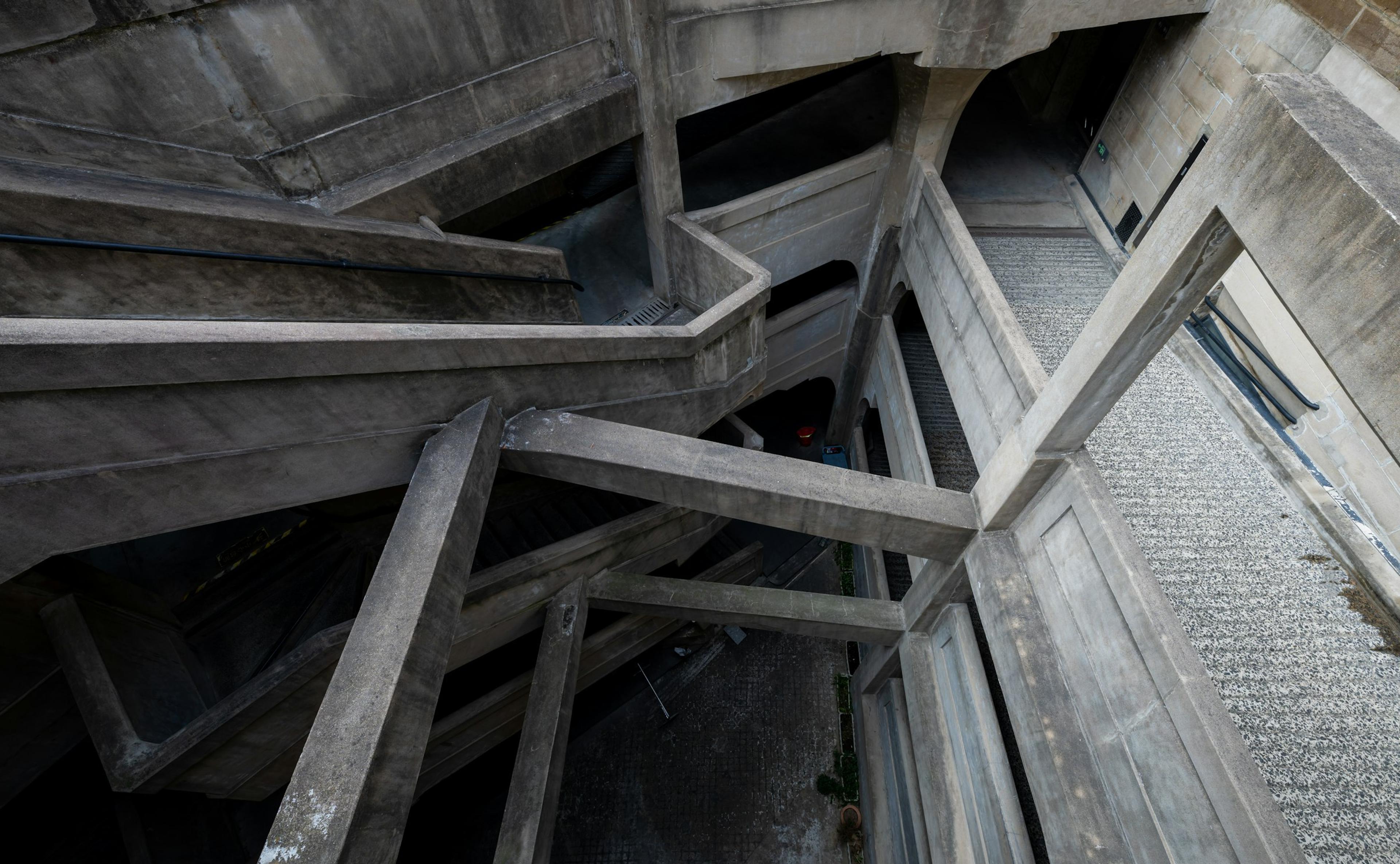 Concrete stairs spiralling down inside a structure