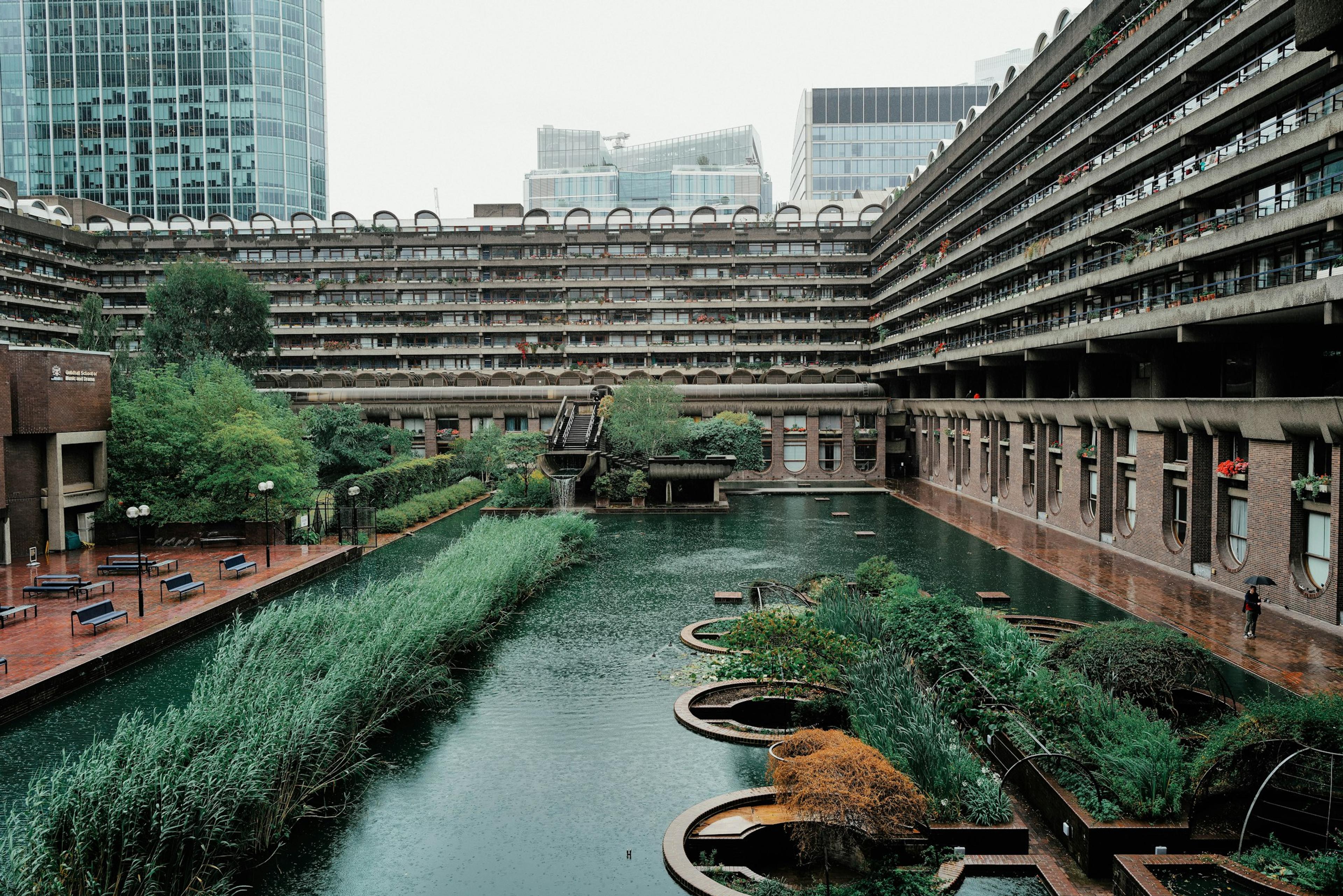 A river running through a city between tall buildings
