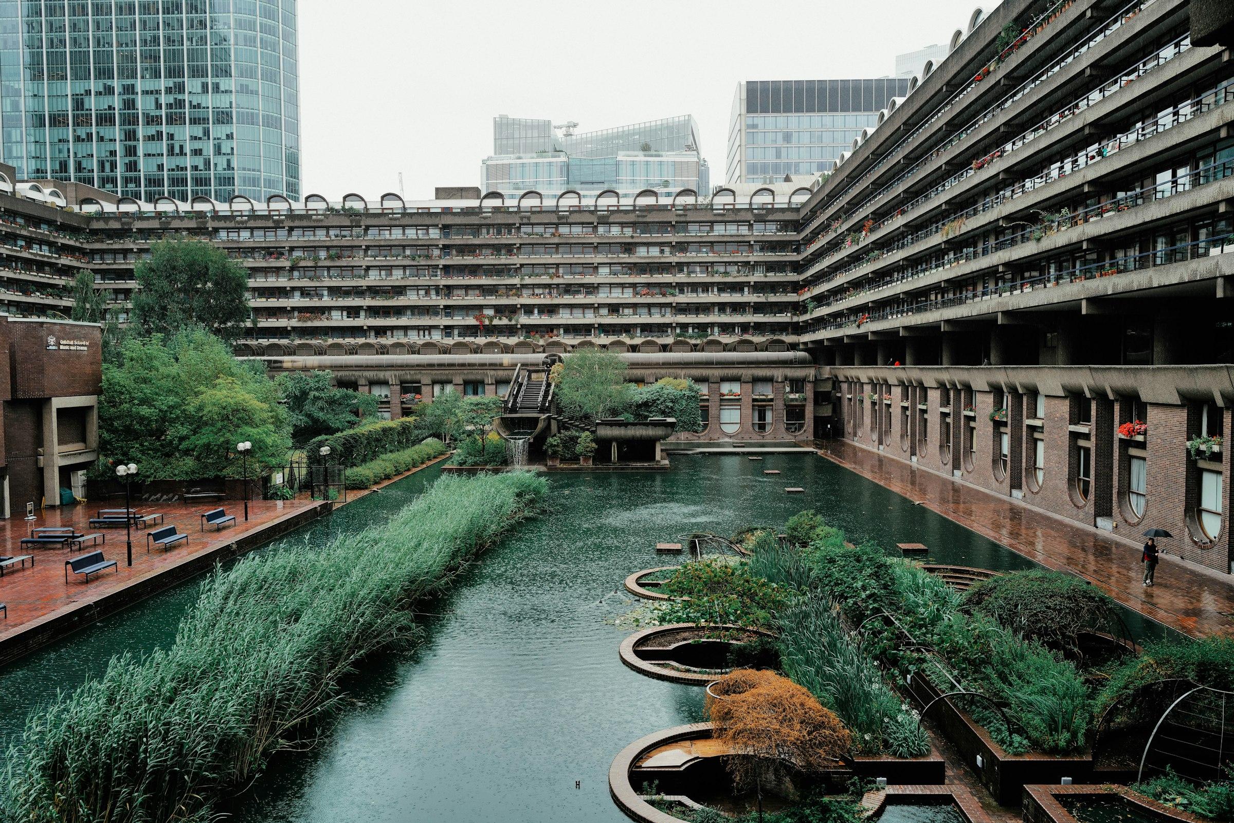 A river running through a city between tall buildings