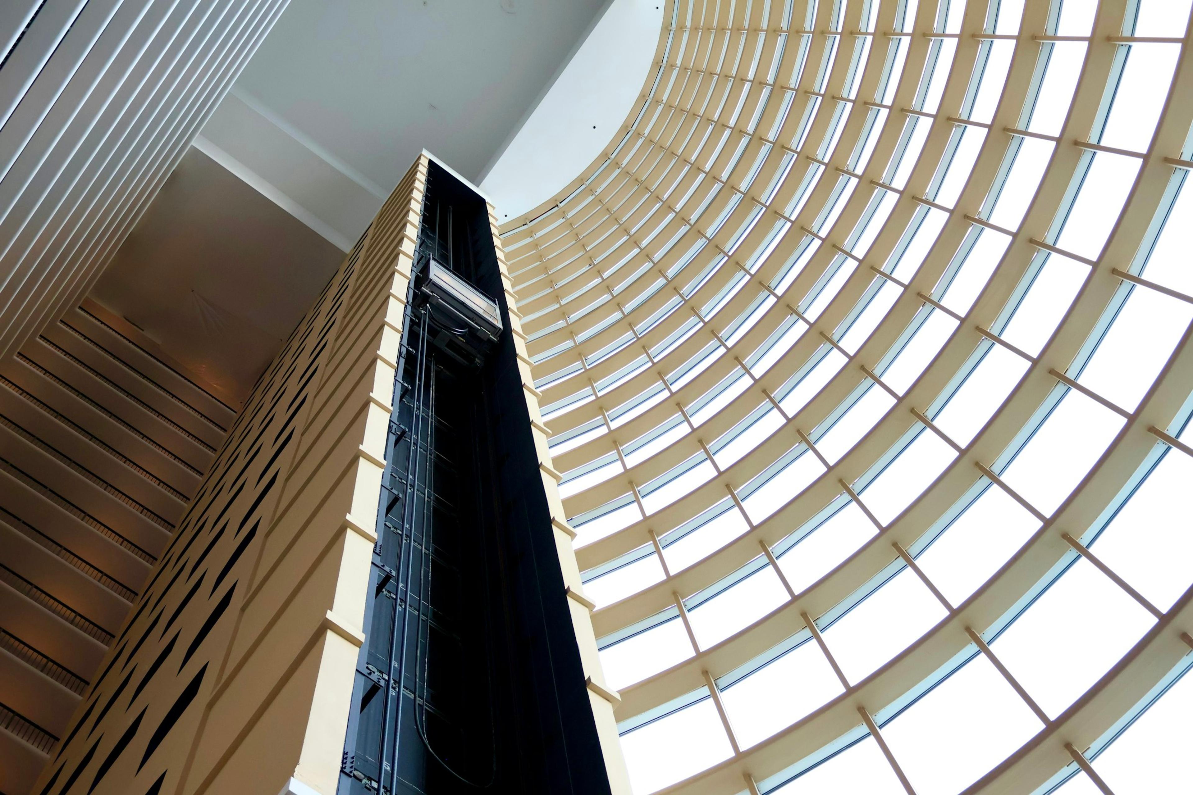 Building interior seen through curved glass windows