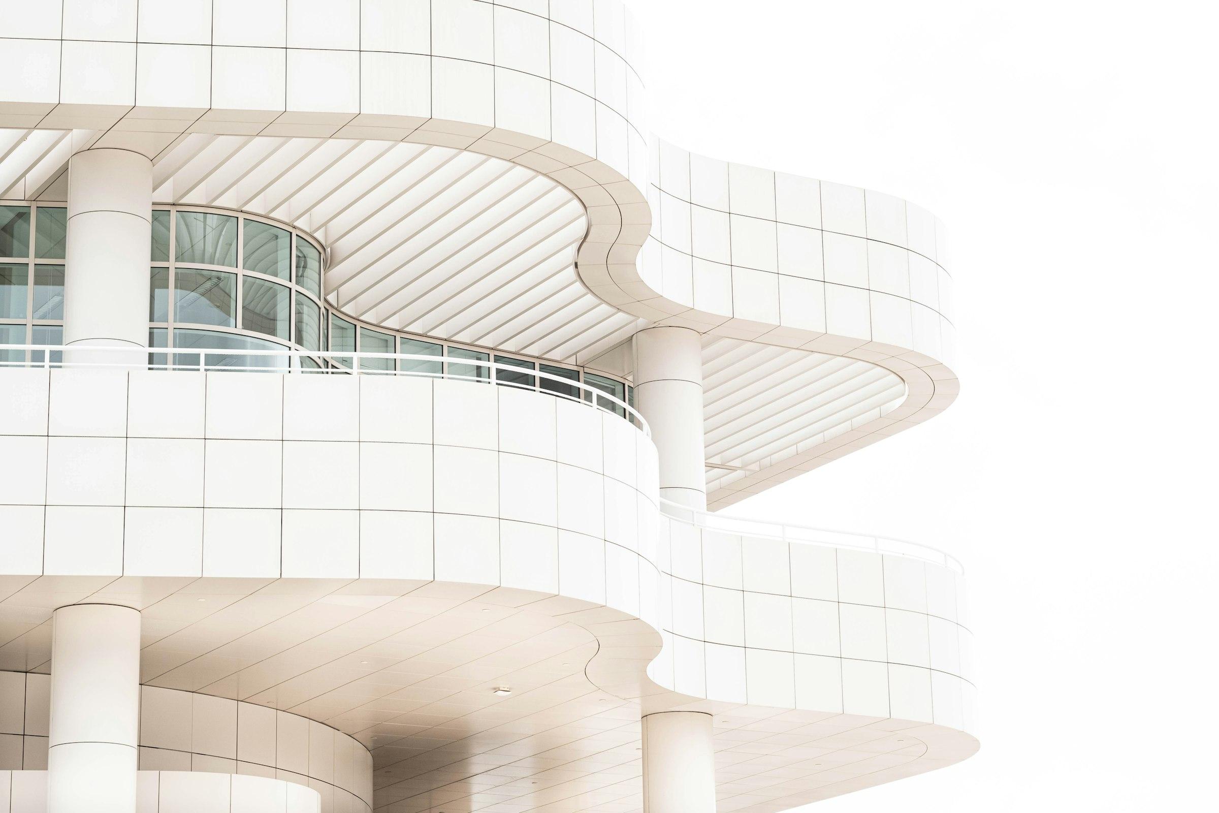 A tall white building with a clock on its side