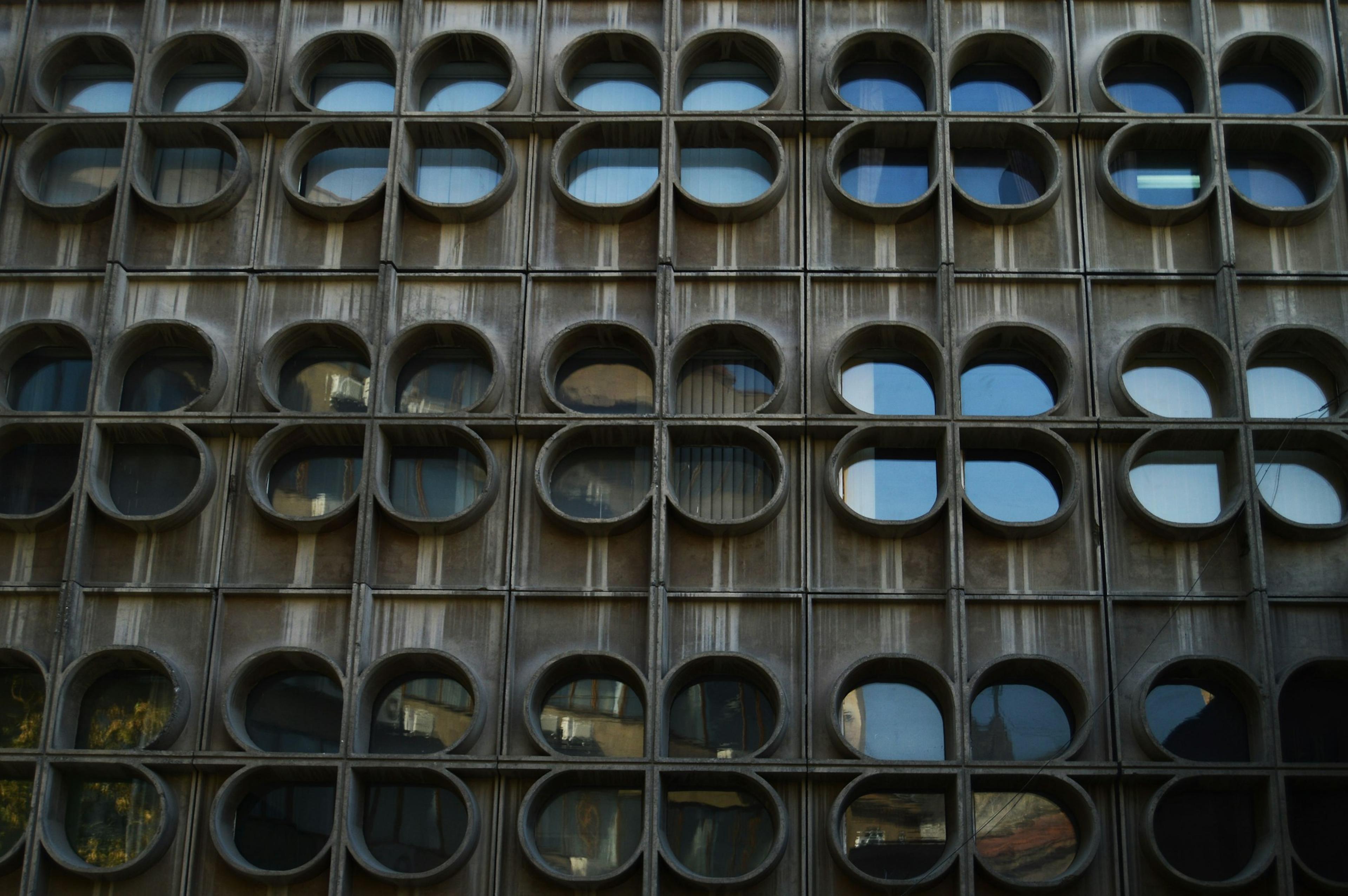 Building facade with repetitive round and clover-shaped windows