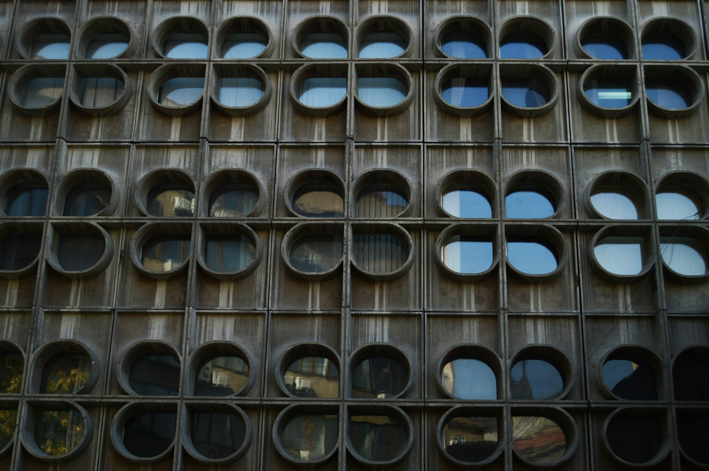 Building facade with repetitive round and clover-shaped windows
