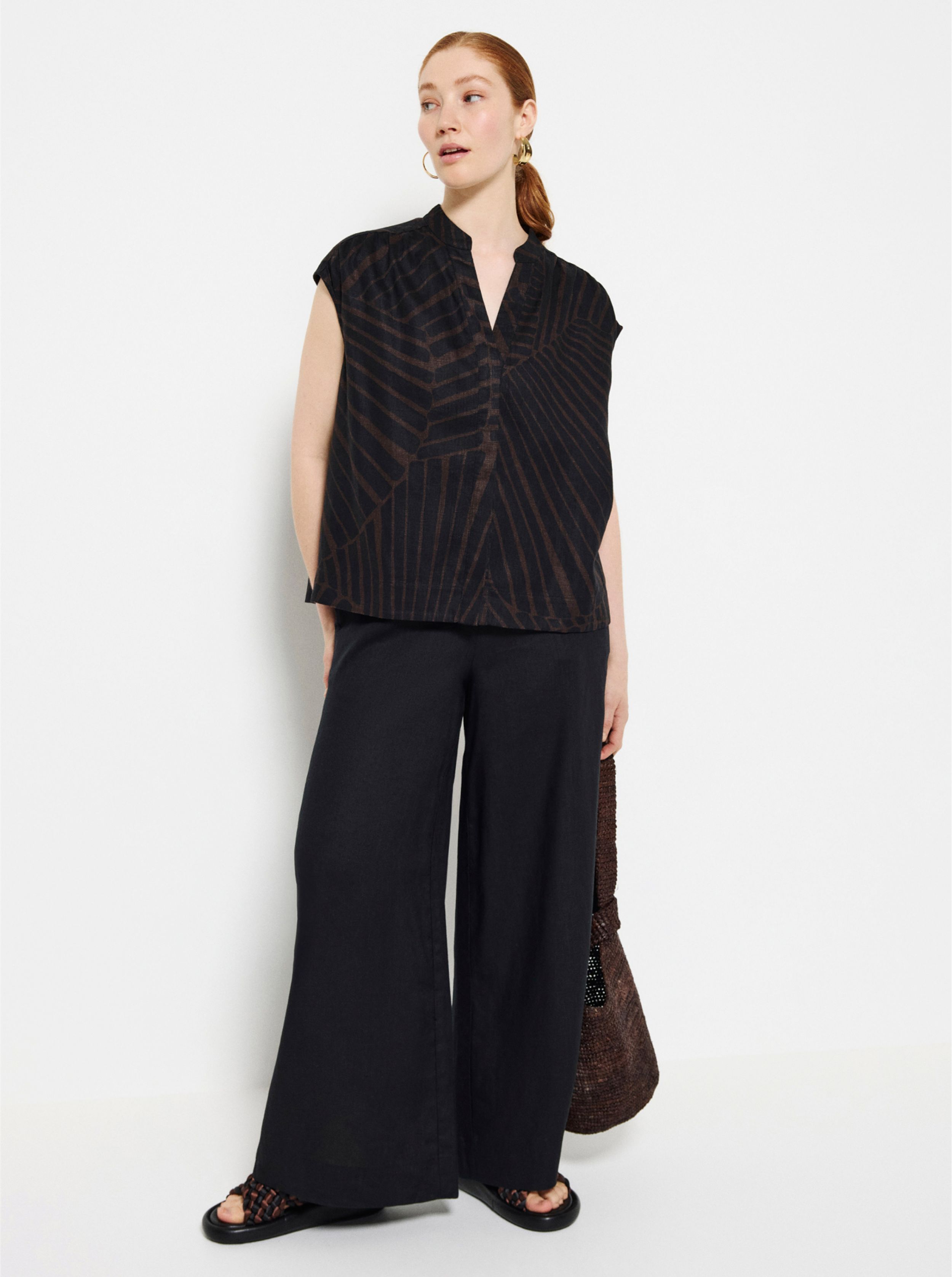 Commonry Linen Shirt and Linen Pants in Burnt Russet with a pair of The Alexa Earrings in front of a white background 