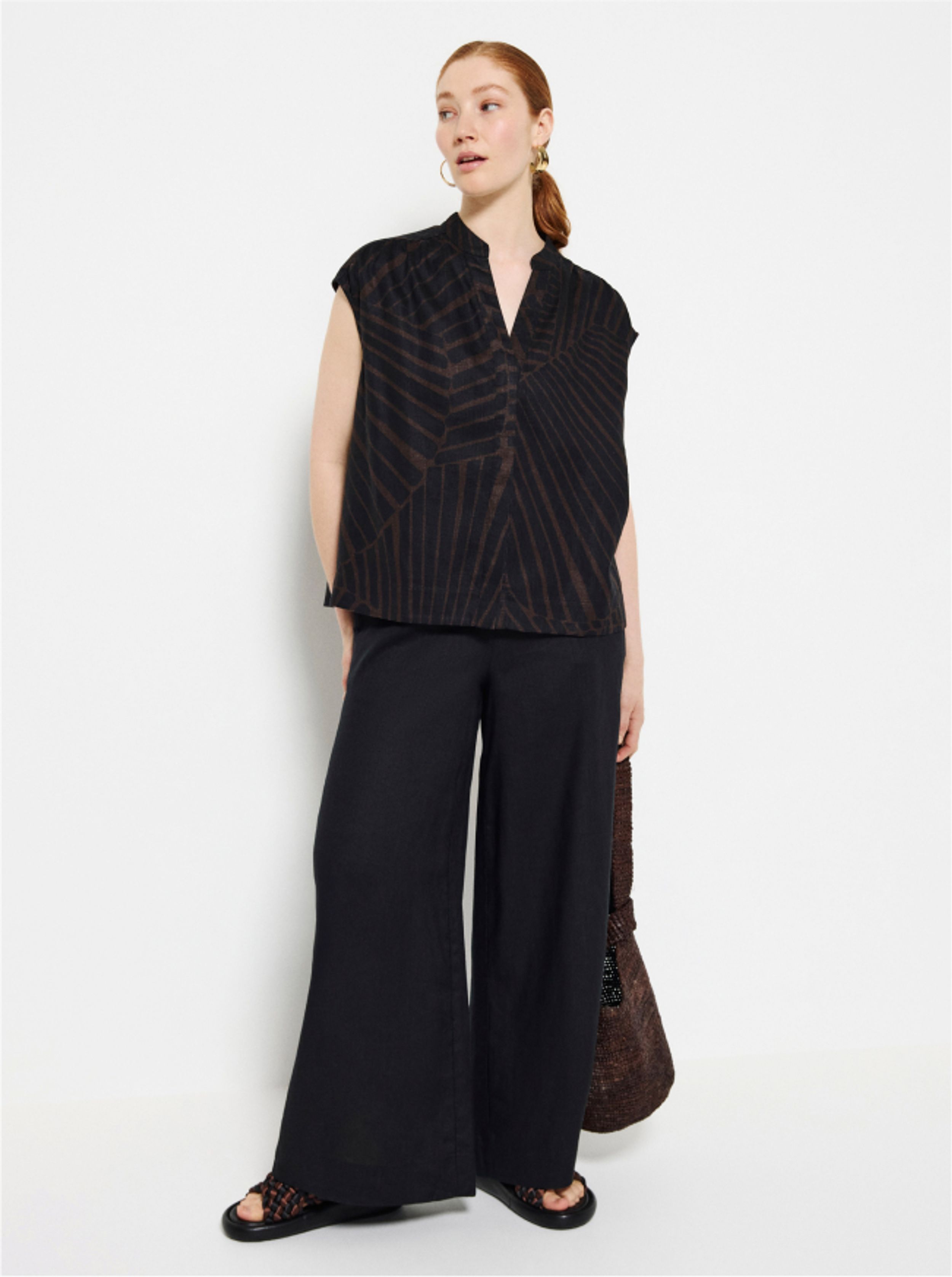 Commonry Linen Shirt and Linen Pants in Burnt Russet with a pair of The Alexa Earrings in front of a white background 