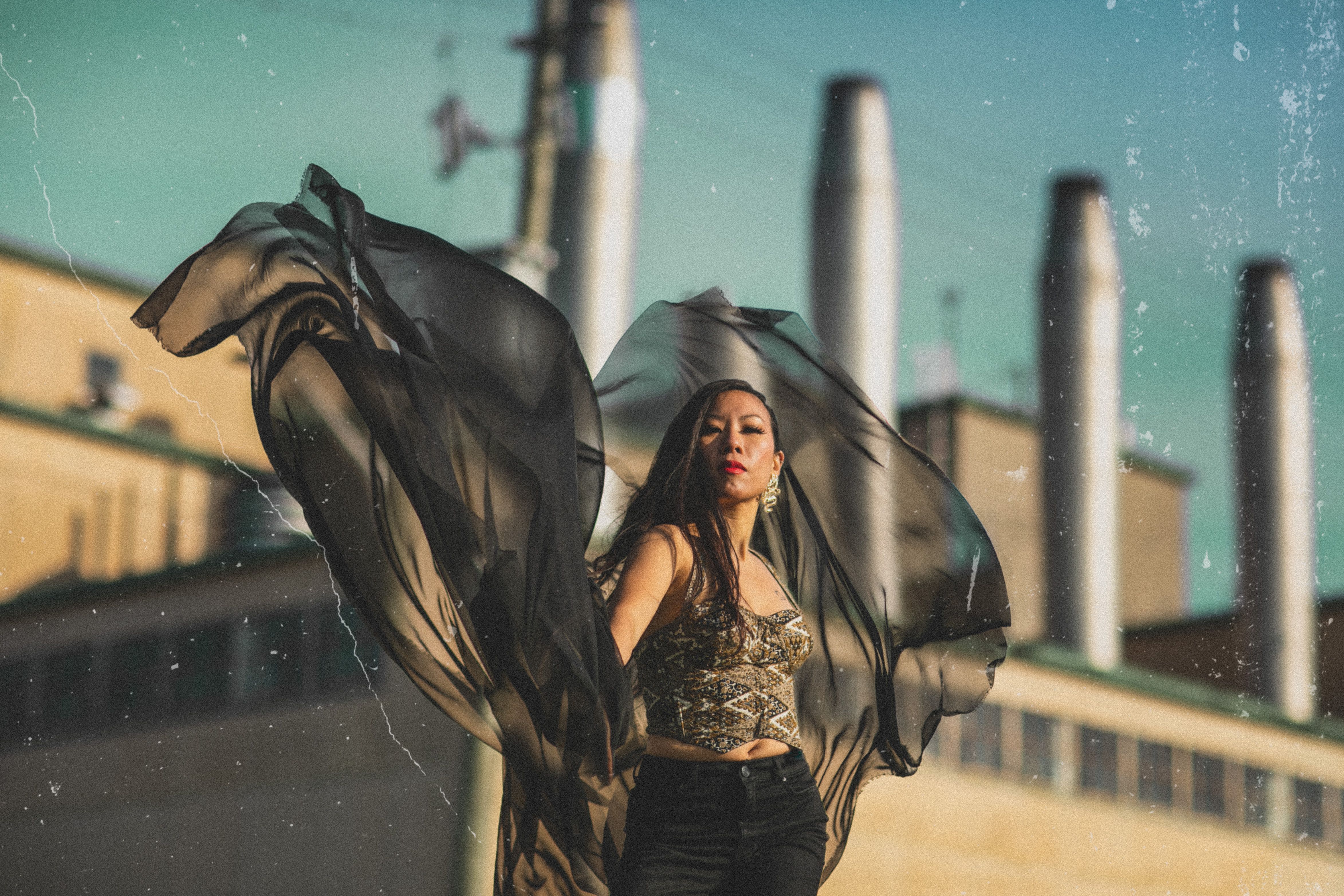 east asian woman in an industrial area with silk scarf