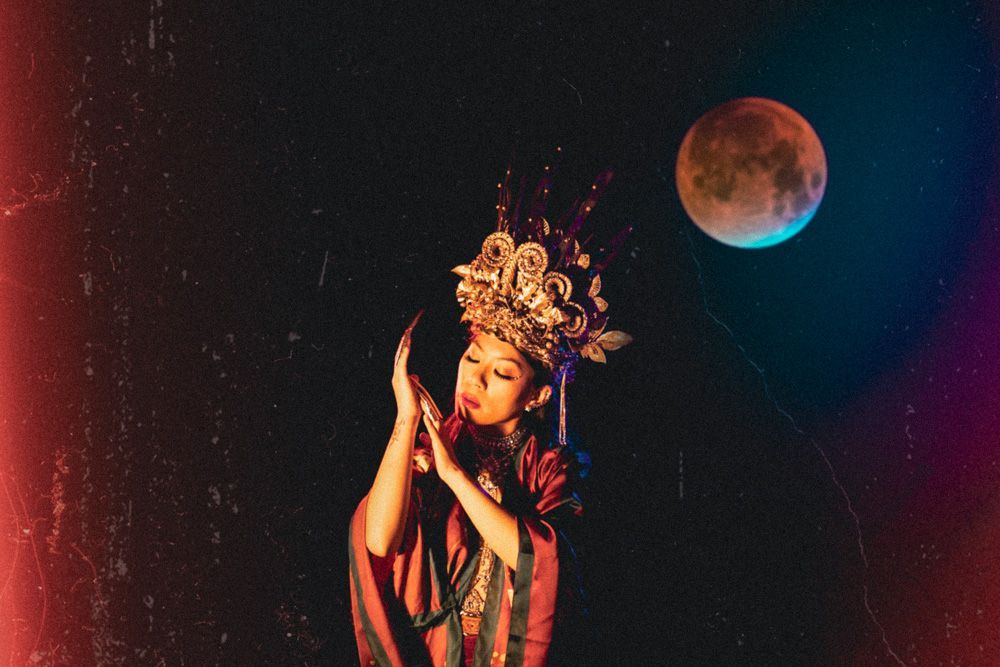east asian woman with crown and a moon