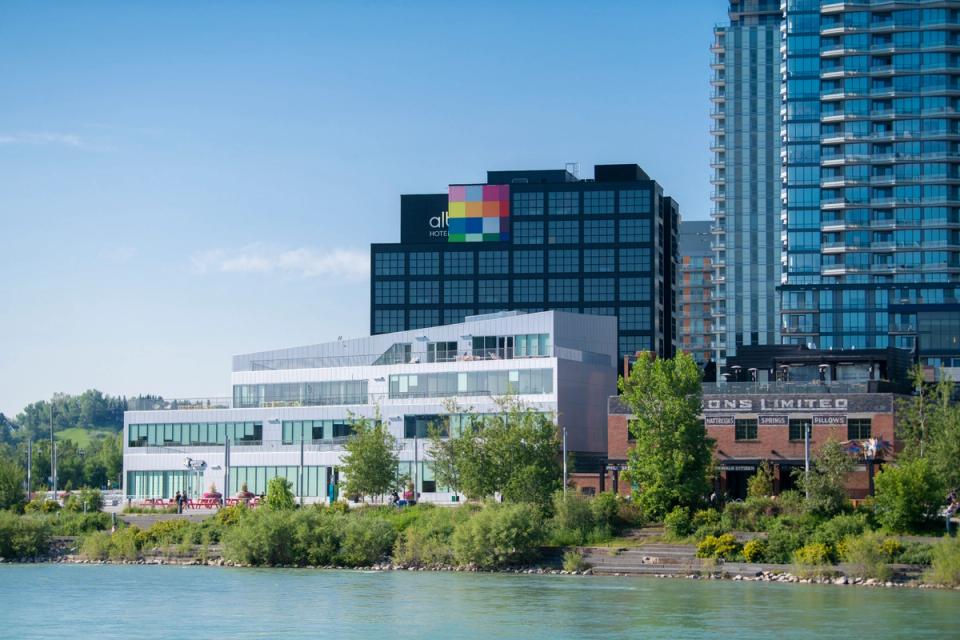 A photograph of RiverWalk in East Village from the north side of the Bow River.