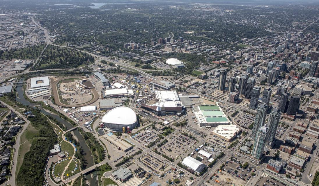 An aerial photograph of the Rivers District from the north-east corner showing the Elbow River, BMO Centre expansion, GMC Stadium and the elbow river.