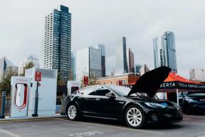 Photograph of a Tesla vehicle with its hood open at a Tesla Supercharging station at Pixel Park.