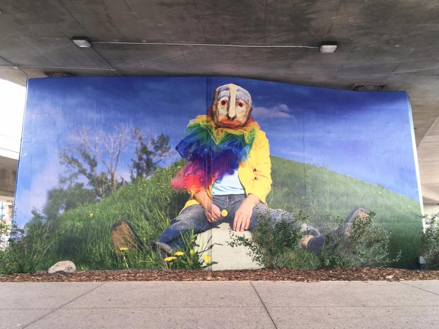 A photograph of a mural on a bridge support column.