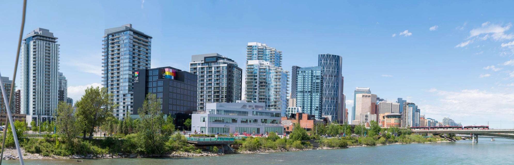 Panoramic photograph of East Village skyline on a sunny day looking west from St. Patrick's Island.