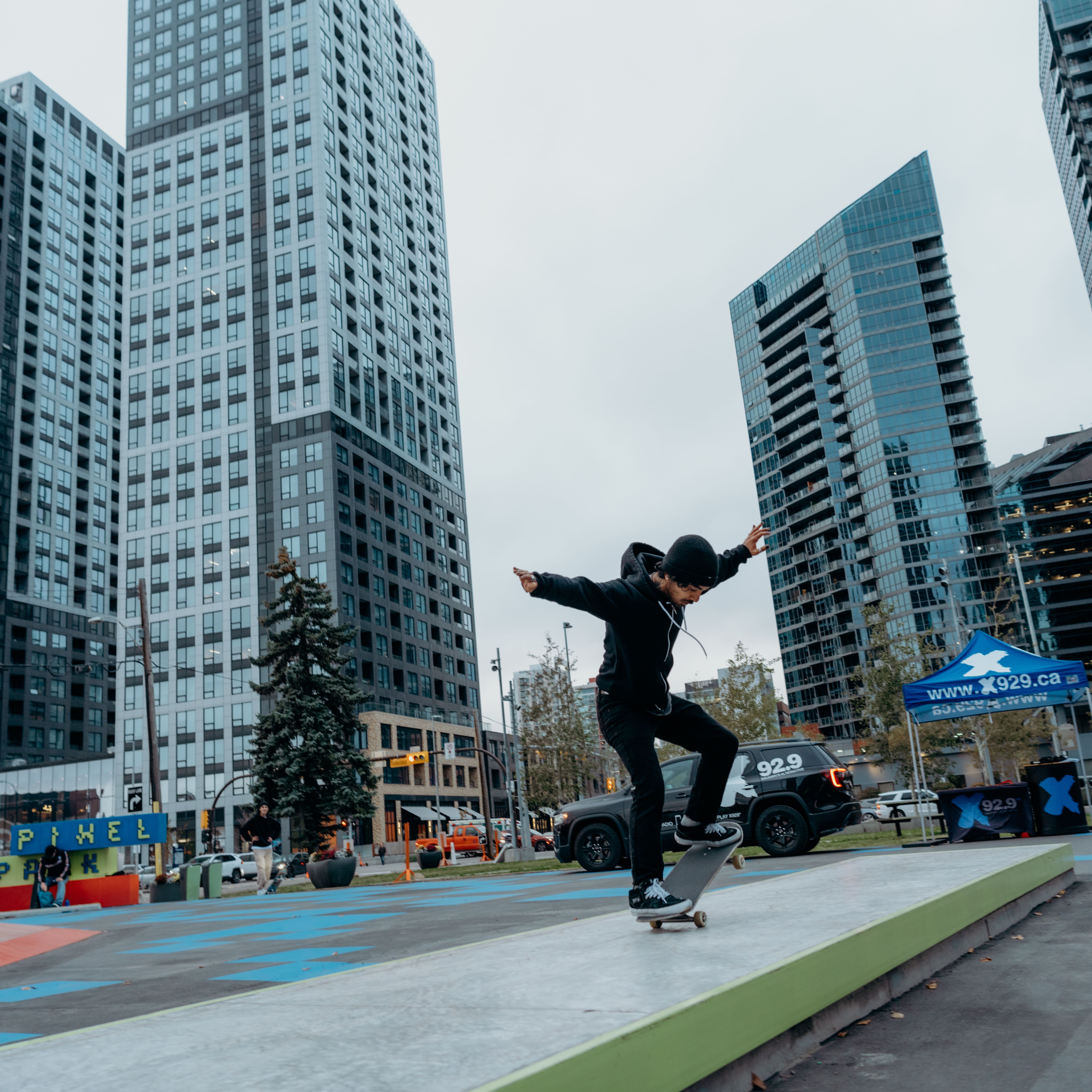 A photograph of a skateboarder doing a trick at Pixel Park in The C+E.