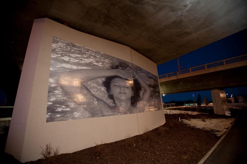 A photograph of a mural on a bridge support column.