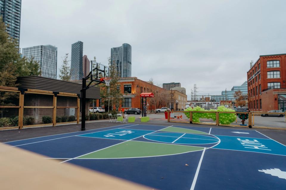 Photograph of a multi-coloured basketball court with balloons in the background at Pixel Park in The C+E.