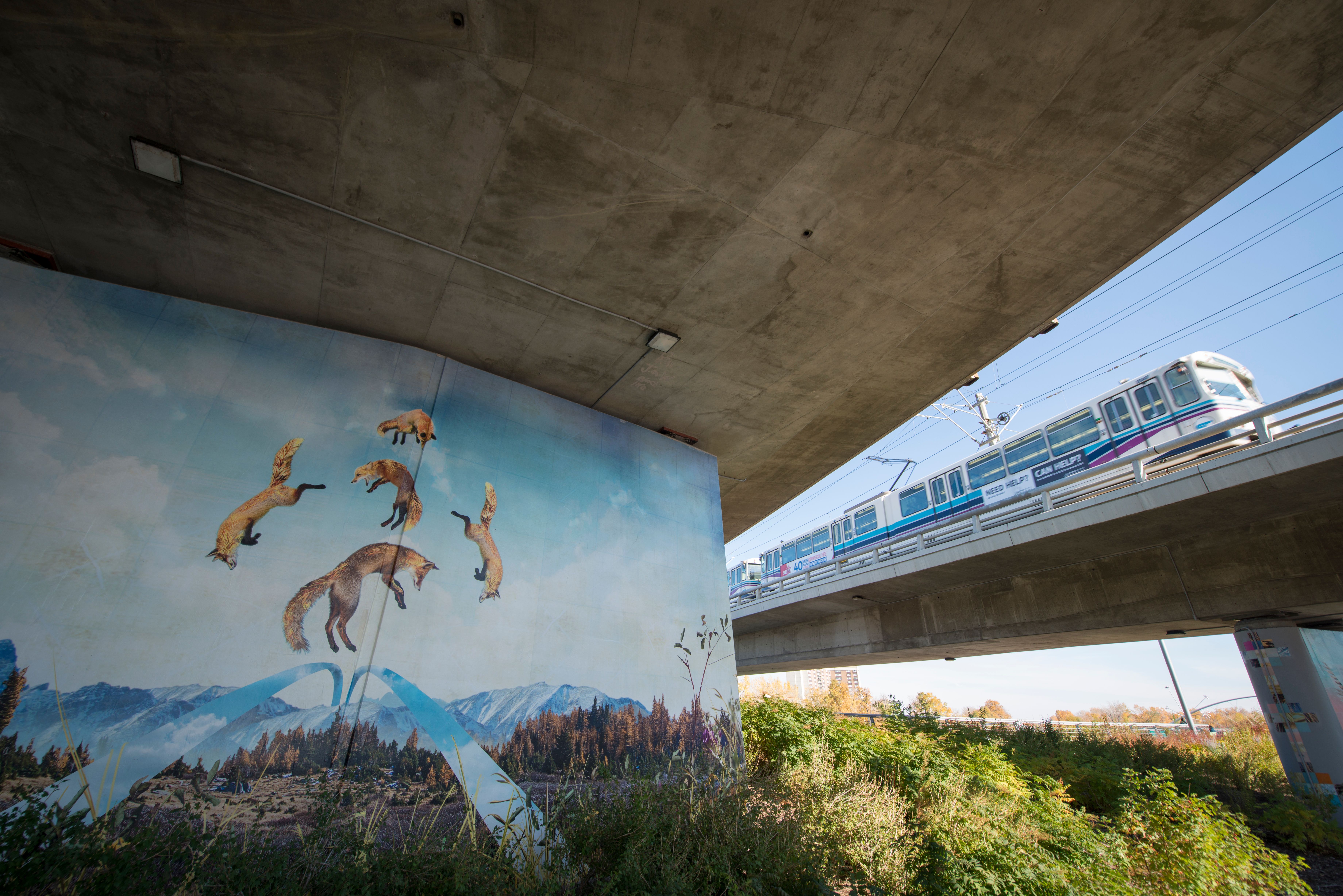 A photograph of a mural on a bridge support column.