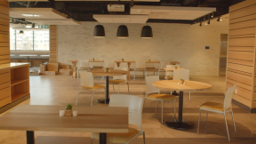 A photograph of many dining tables in a common area