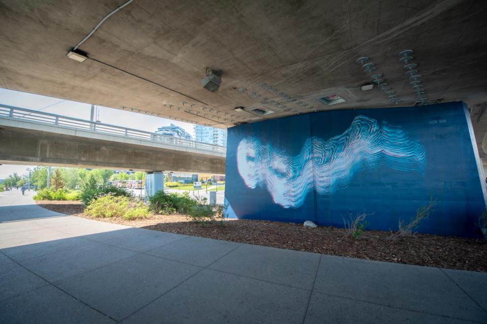 A photograph of artwork on support column under bridge