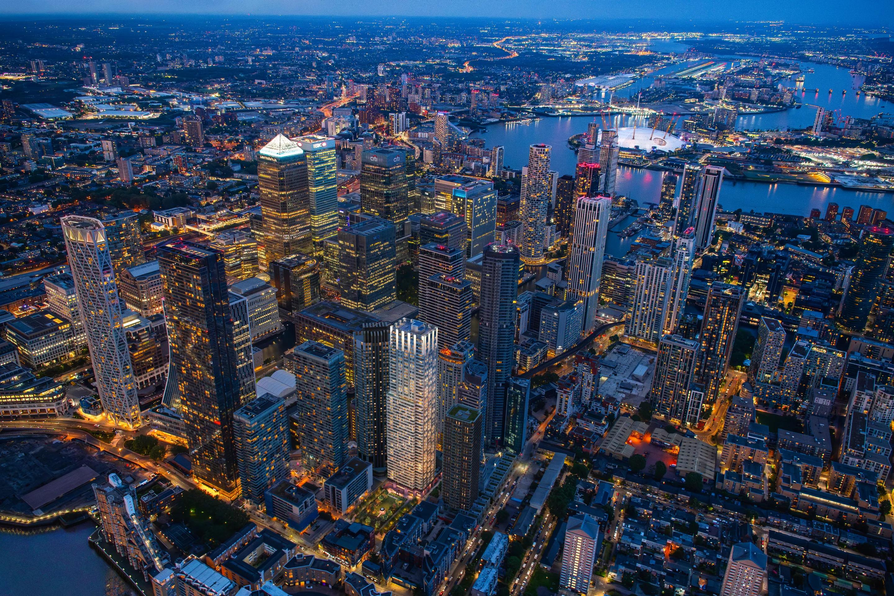 Canary Wharf towers and the Thames lit at night