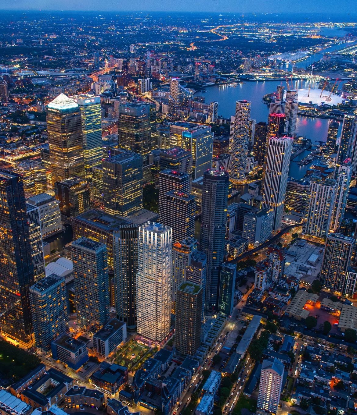 Canary Wharf towers and the Thames lit at night