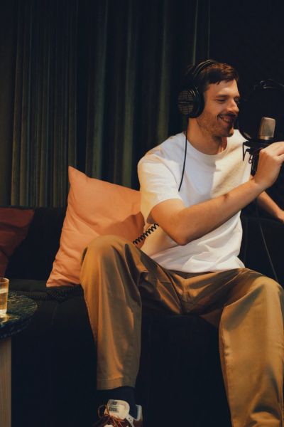 A resident recording a podcast at a standing microphone