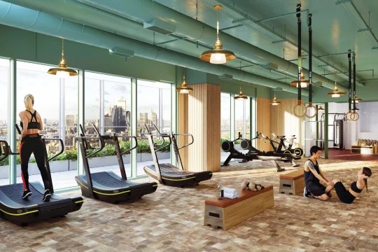 Gym with treadmills under a green ceiling, city beyond