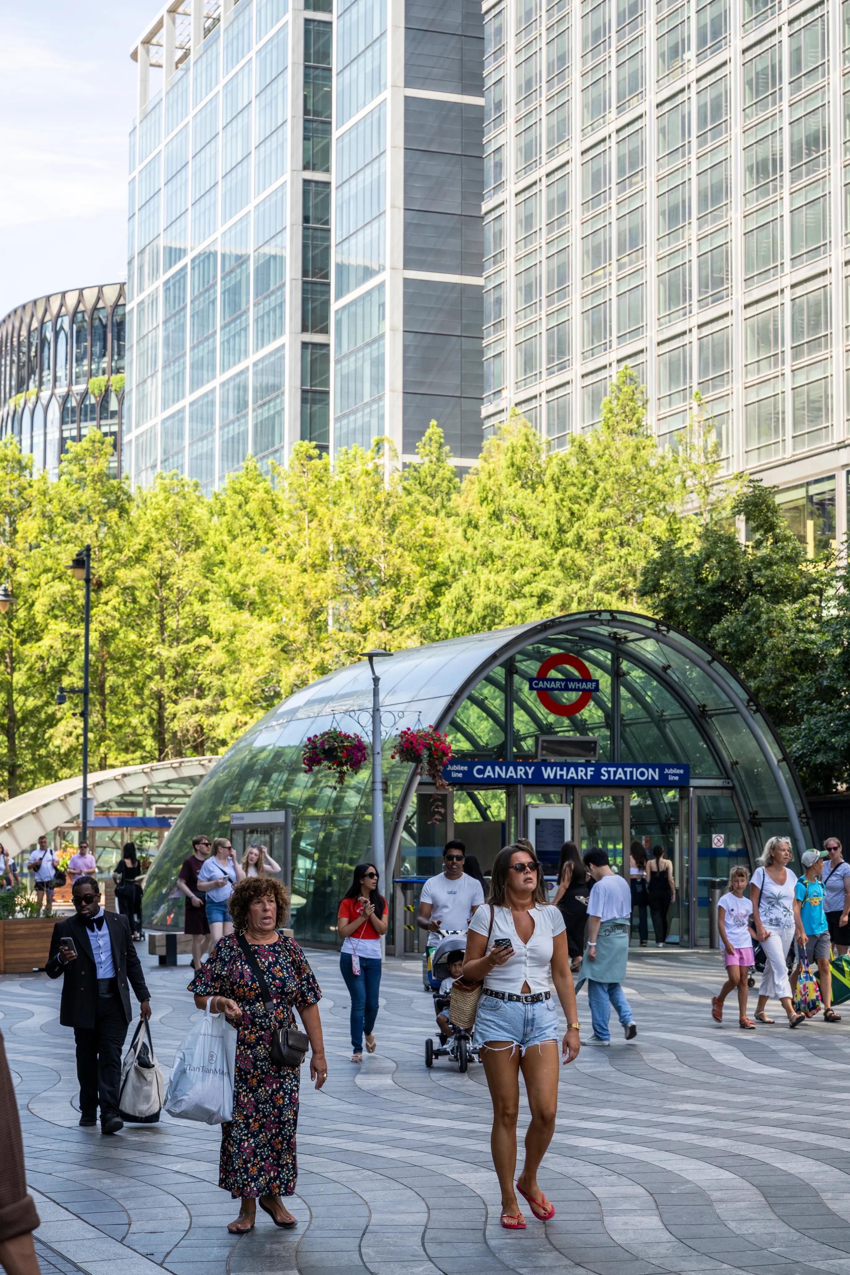 Commuters outside the domed Canary Wharf station entrance