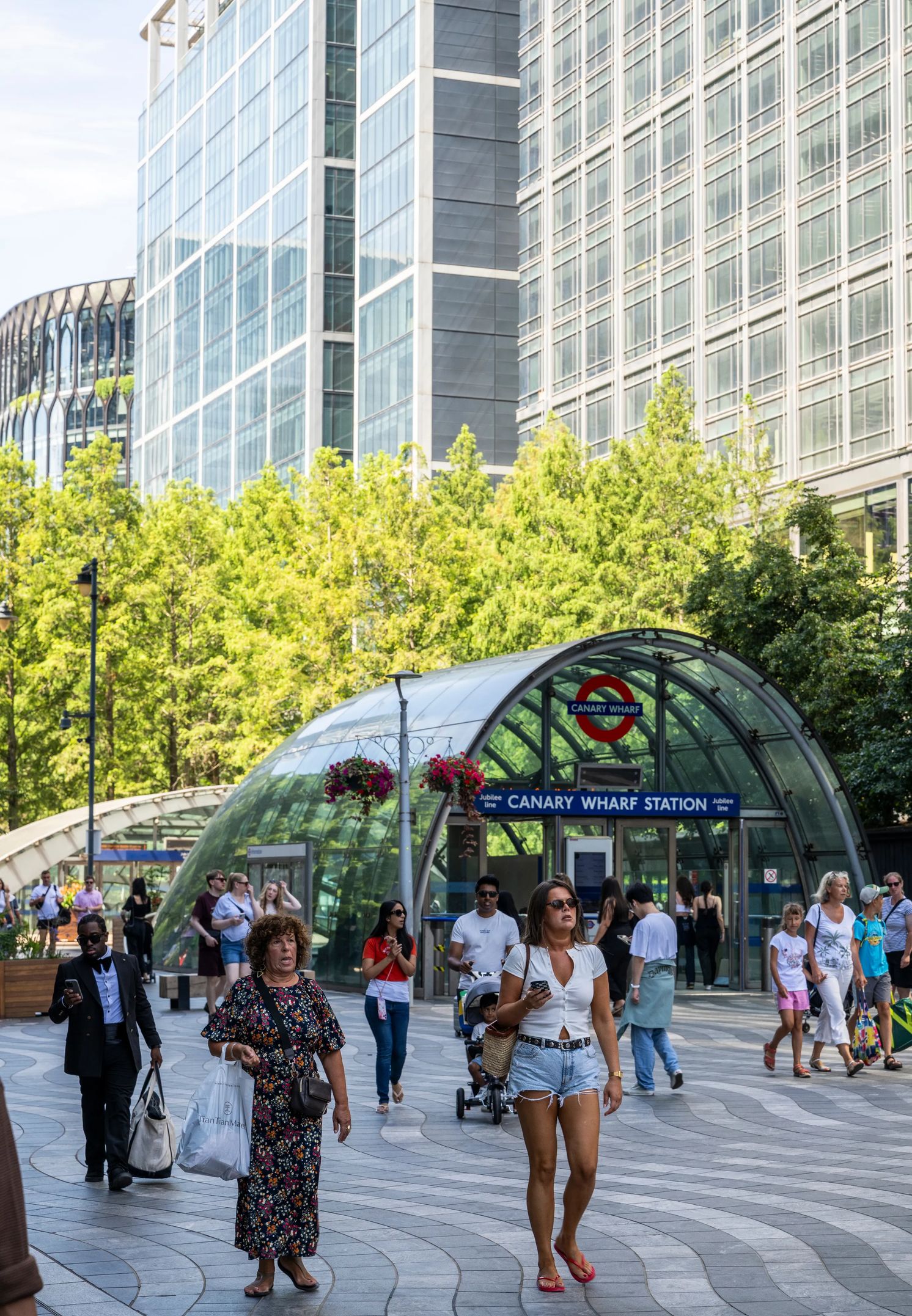 Commuters outside the domed Canary Wharf station entrance