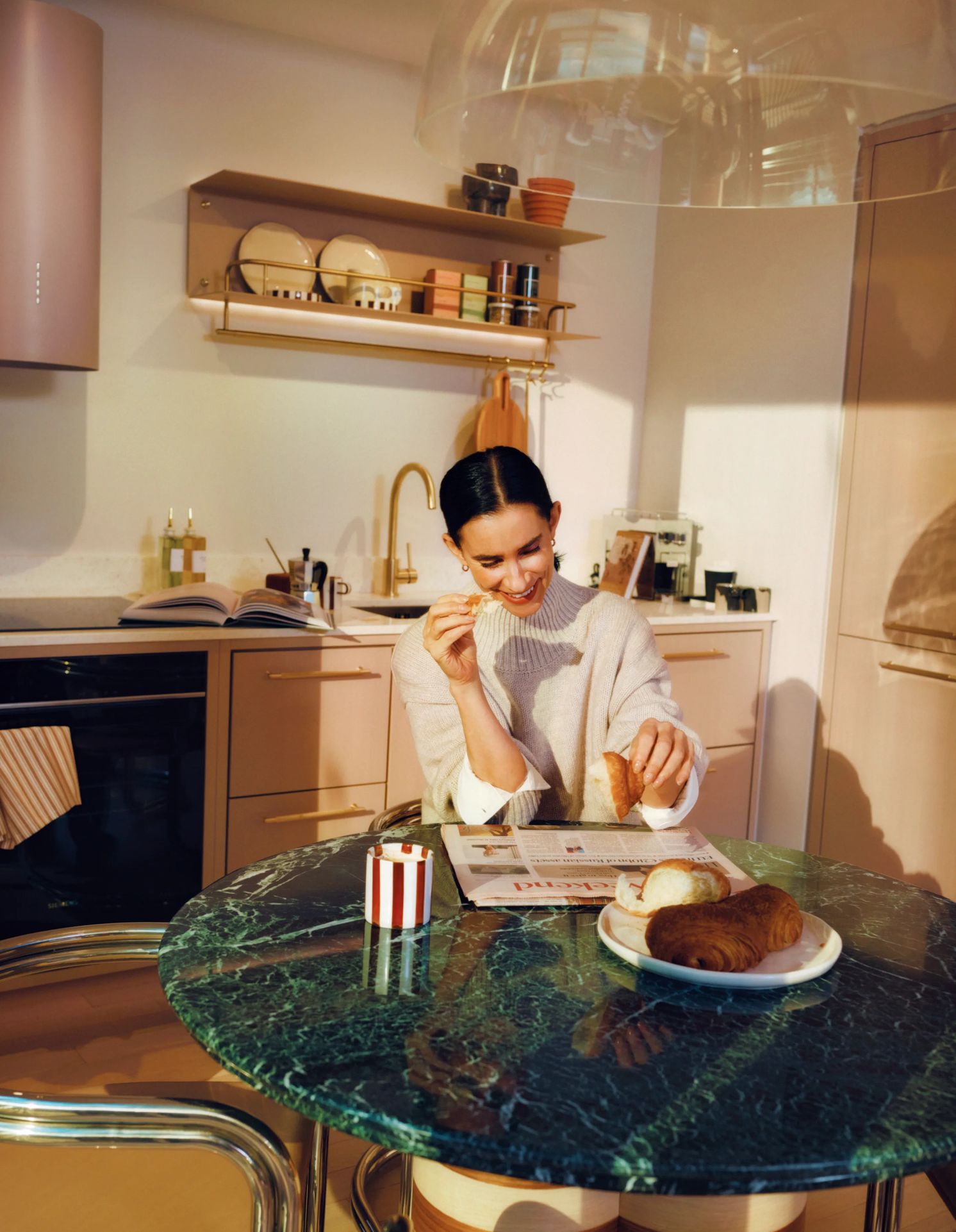 Woman having breakfast at a green marble kitchen island