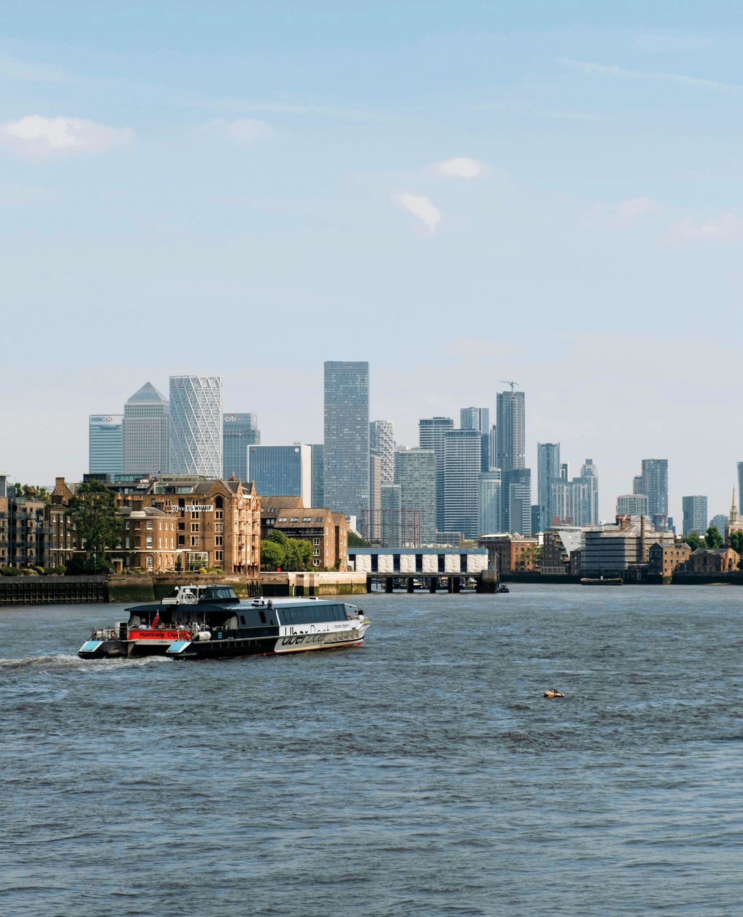 River boat passing the Canary Wharf skyline