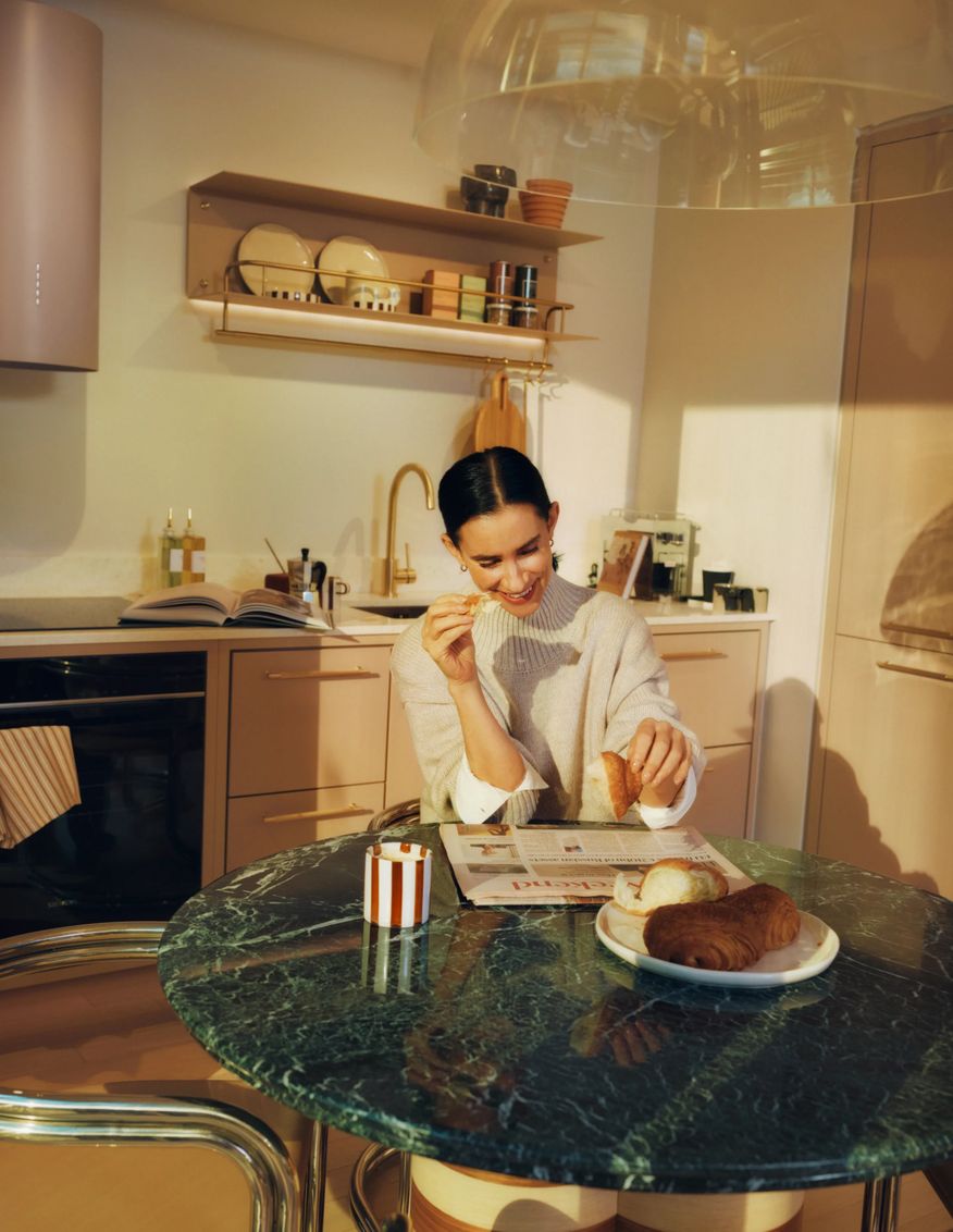 Resident at a marble breakfast table in a bright kitchen