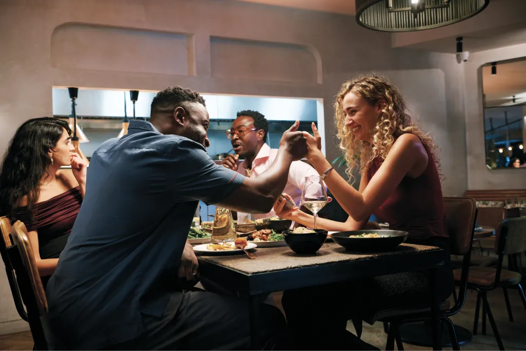 Friends sharing dinner at a restaurant table