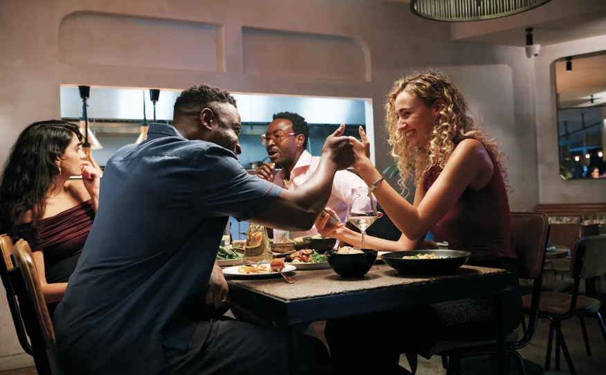 Friends sharing dinner at a restaurant table
