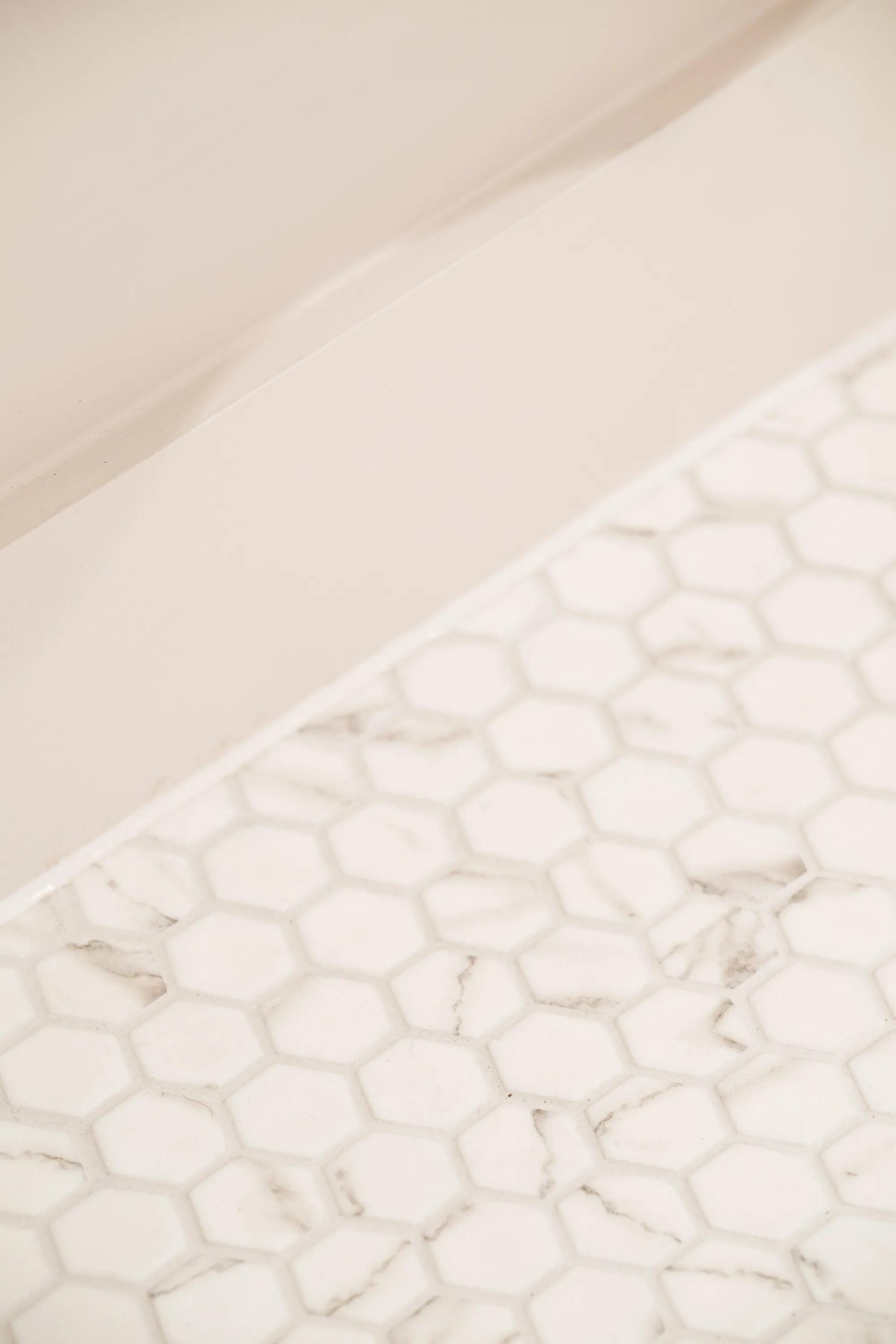 Marble worktop meeting a hexagonal mosaic tile floor