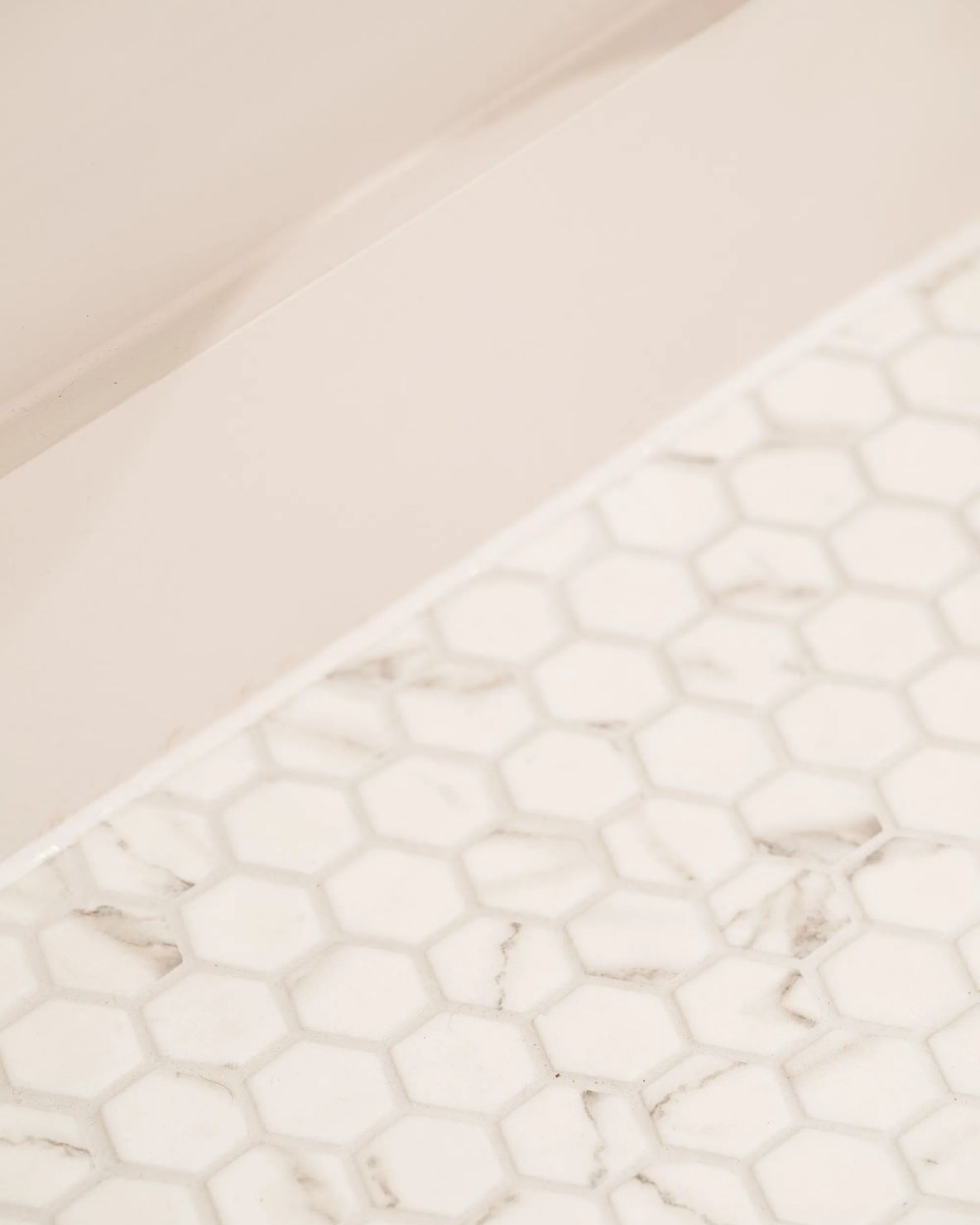 Marble worktop meeting a hexagonal mosaic tile floor