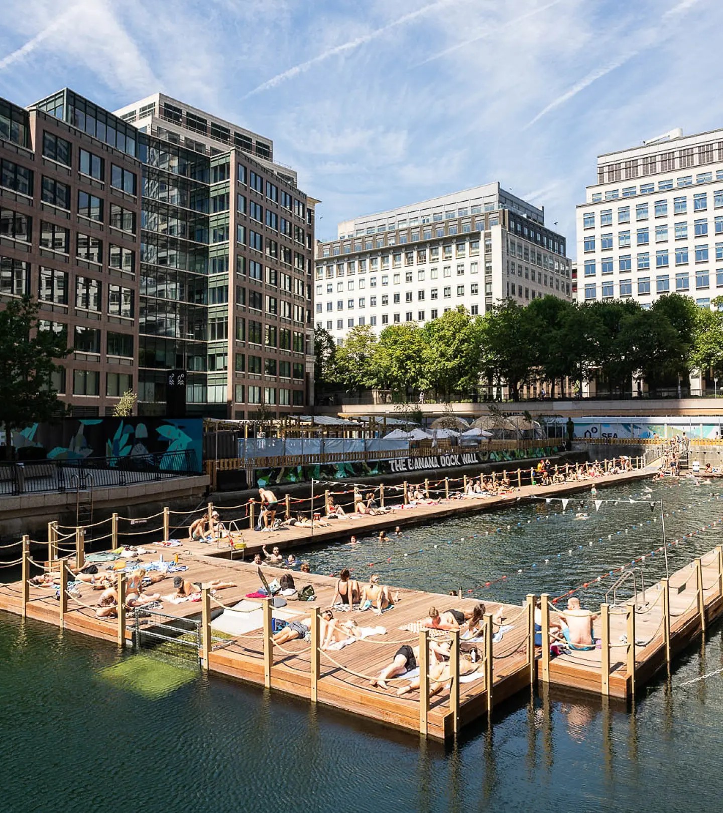 Swimmers and sunbathers on a floating dock lido