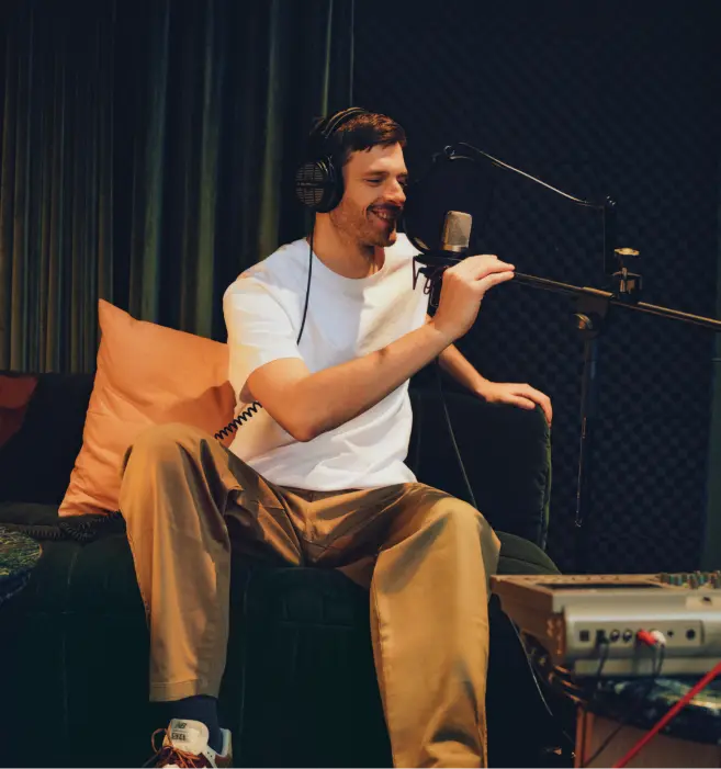 Man speaking into a microphone in a podcast studio