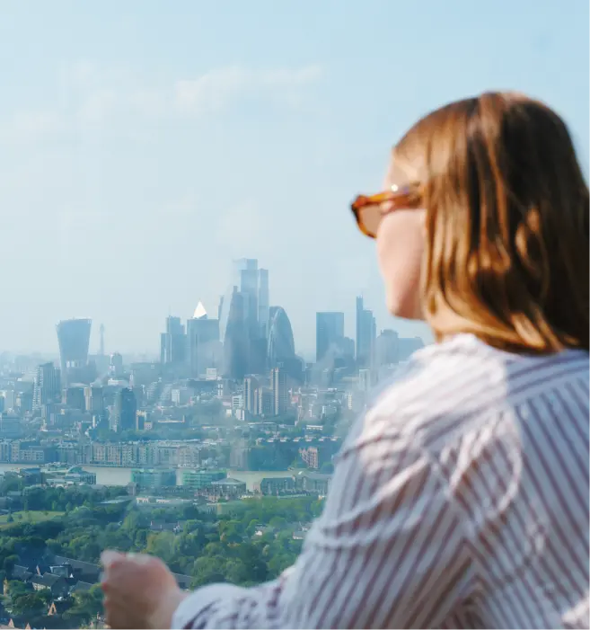 Woman on a balcony looking towards the London skyline
