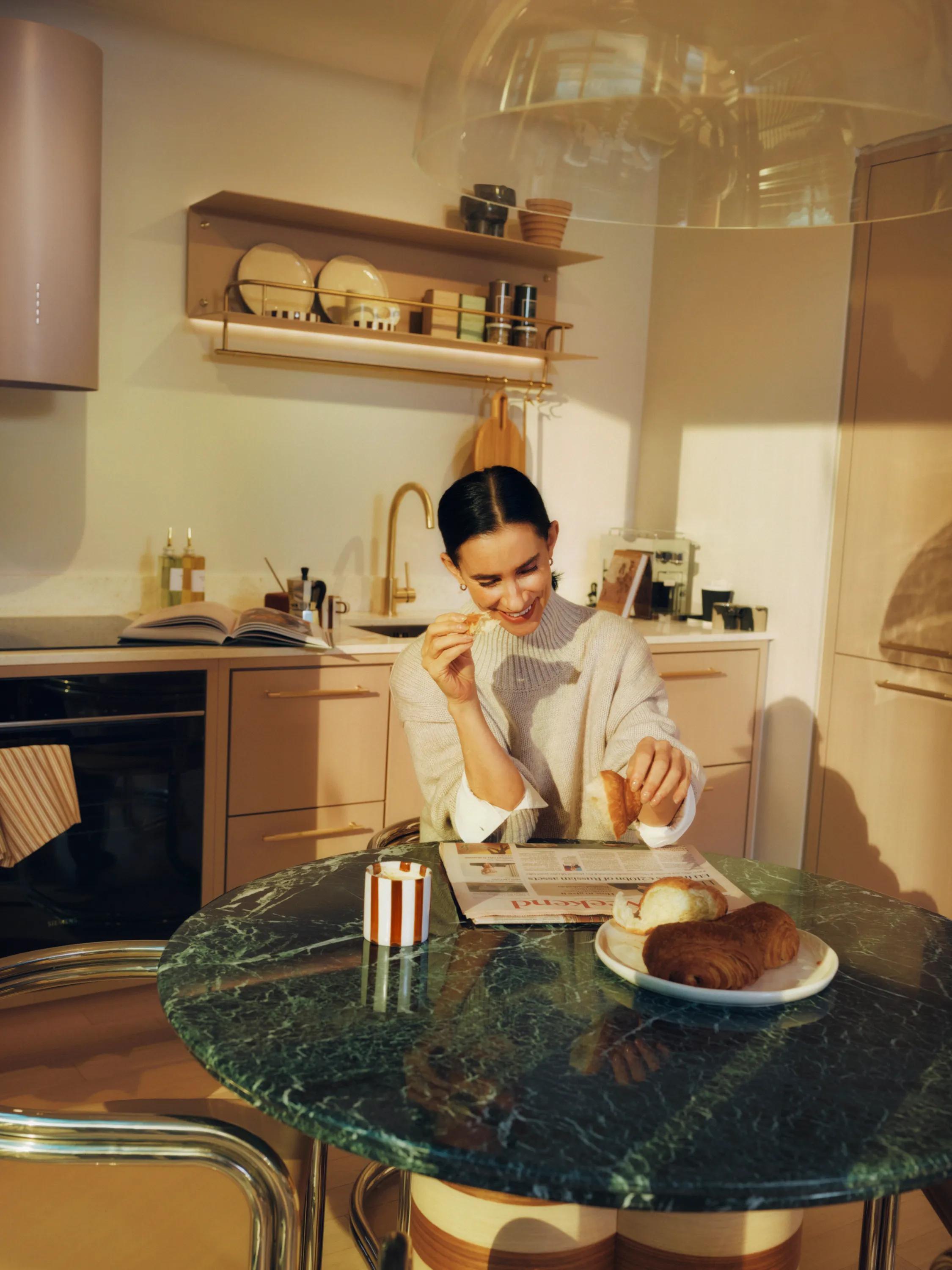 Coffee and a pastry on a marble kitchen island