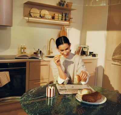 Coffee and a pastry on a marble kitchen island