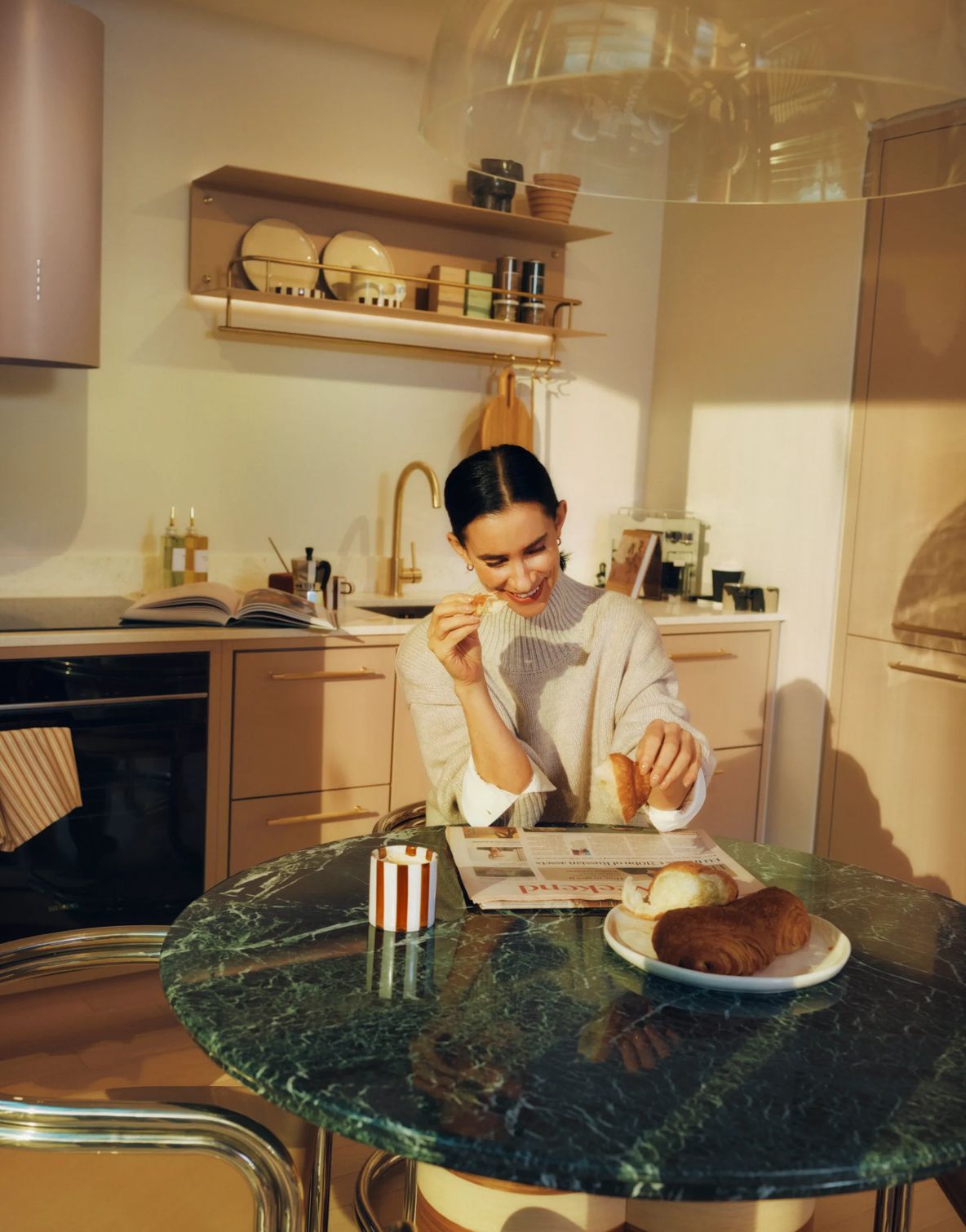 Coffee and a pastry on a marble kitchen island