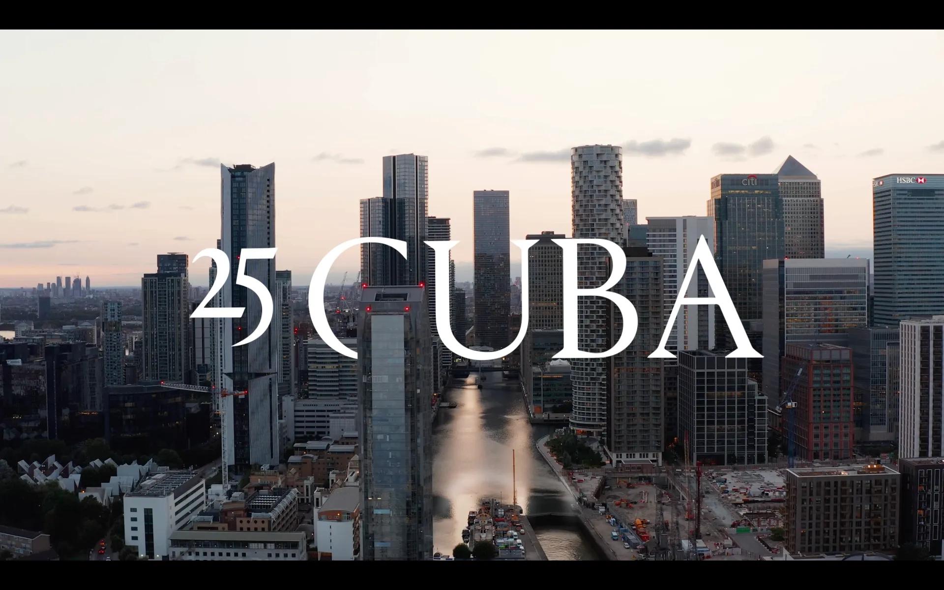 Aerial title frame over the Canary Wharf towers reading 25 Cuba