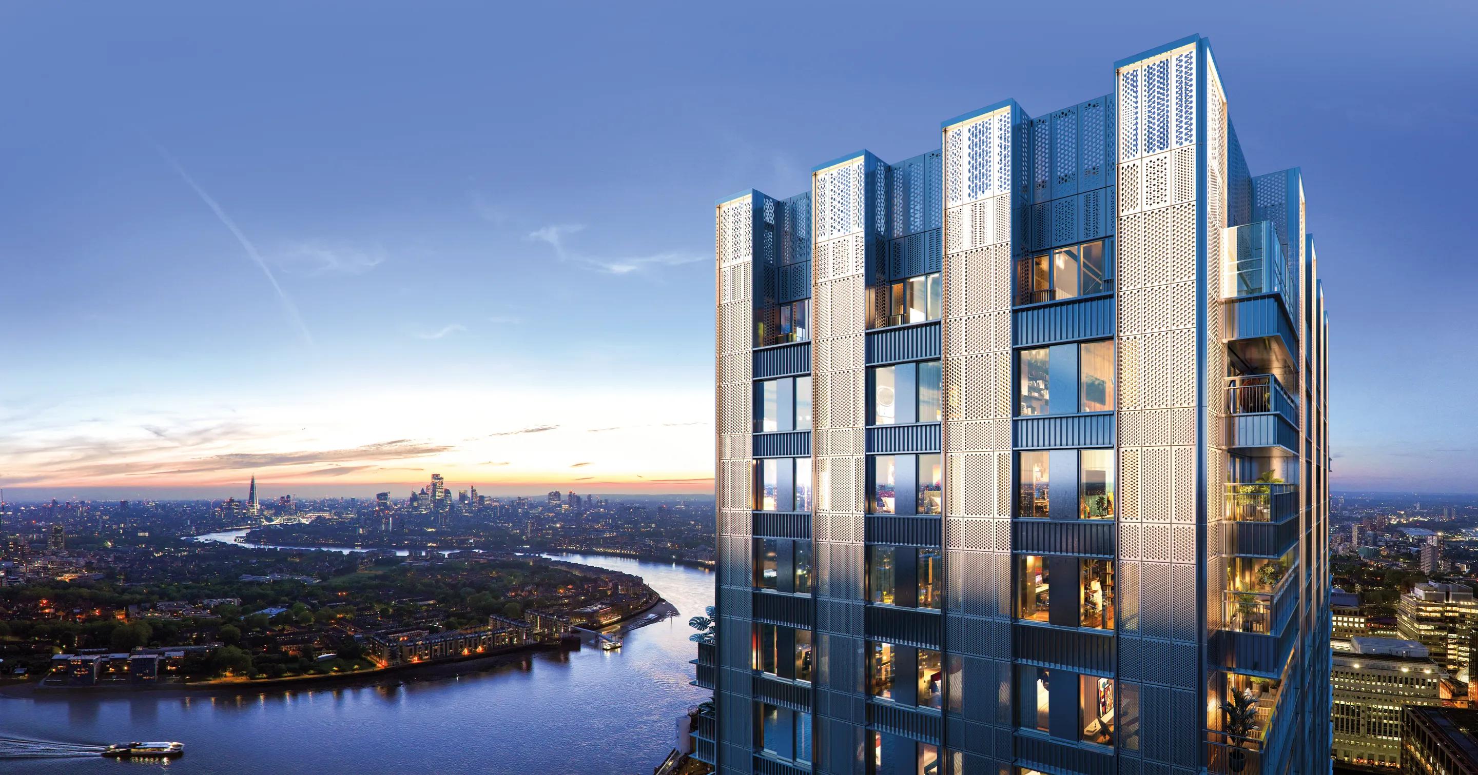 Lit tower above the Thames at dusk, London skyline beyond