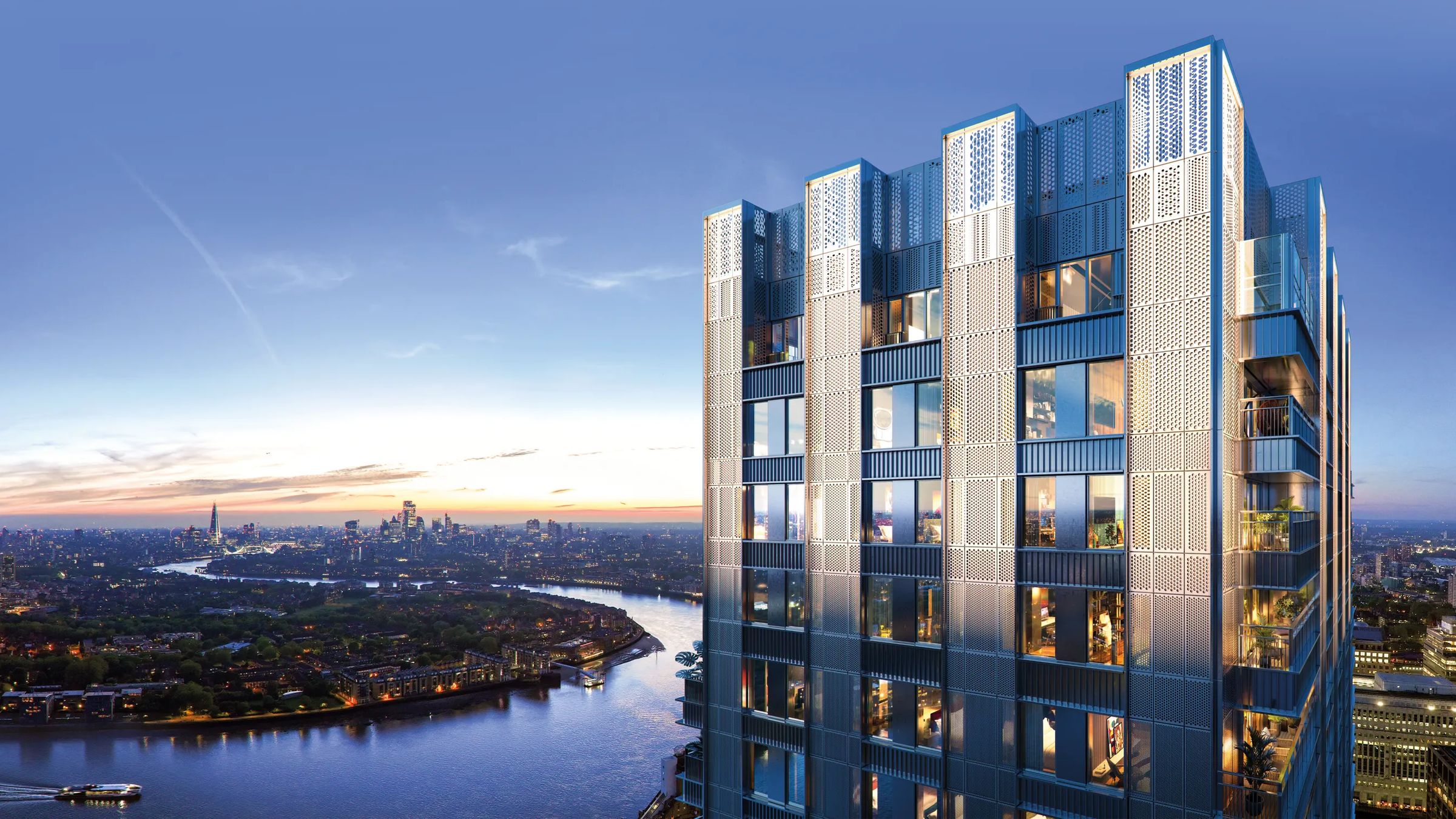 Lit tower above the Thames at dusk, London skyline beyond