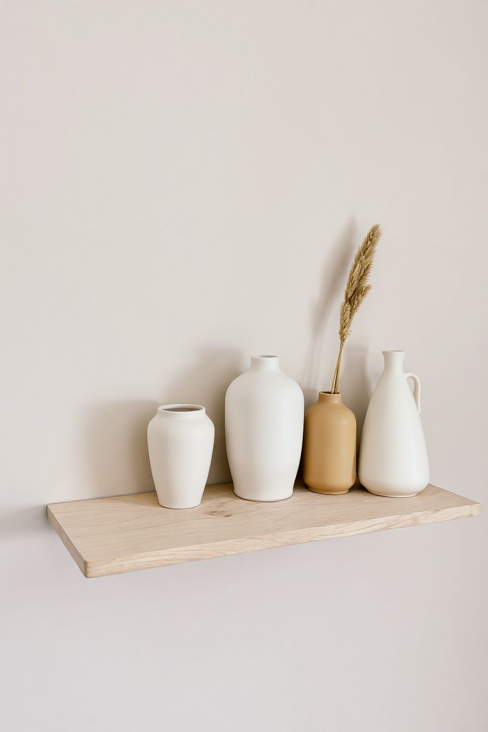 Cream Stoneware Vase Cluster on a Bleached Wood Shelf – coastal — bedroom coastal — bedroom decor · Neutral Coastal Bedroom: 15 Calm Designs in Sand Cream and Warm White