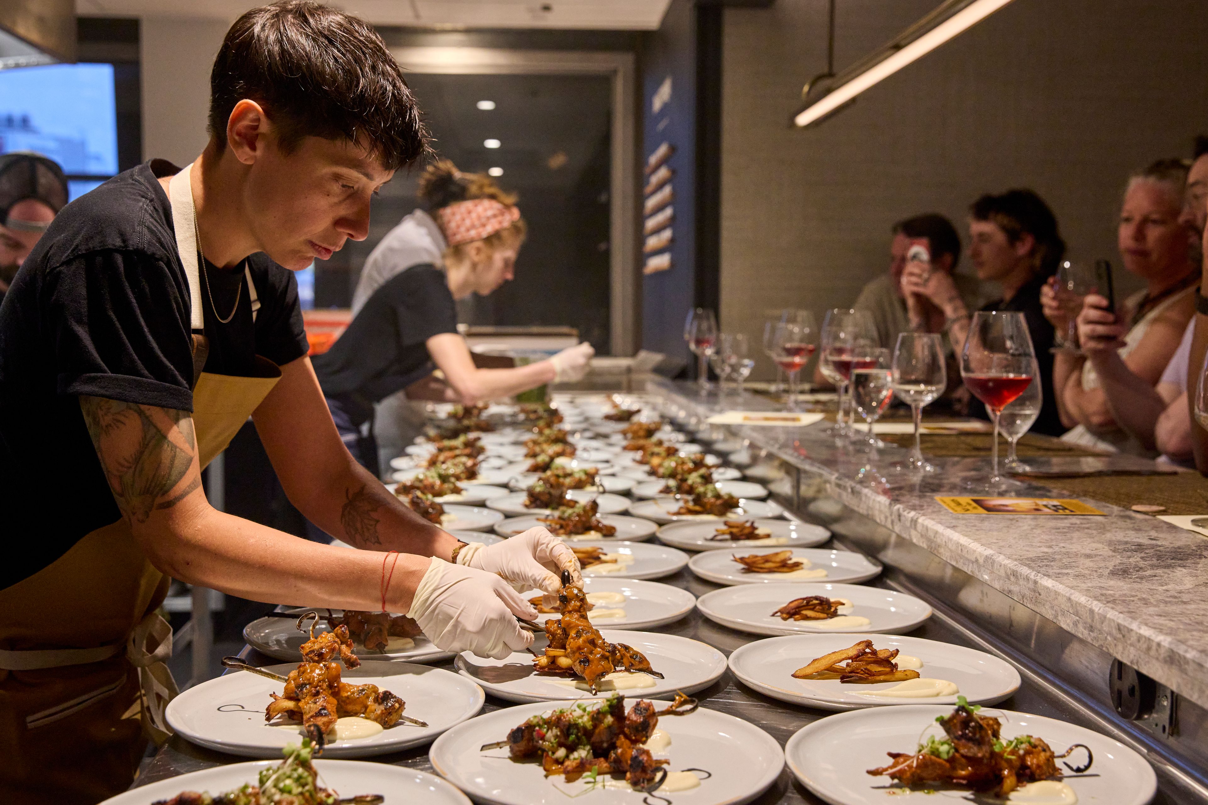 Chefs plating in an open kitchen